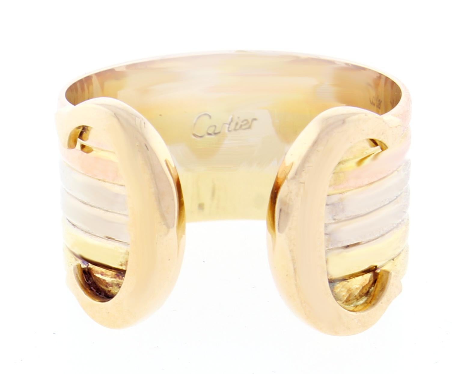 From Cartier, their iconic double C de Cartier decor trinity ring. Crafted from white yellow and pink 18 Karat gold. 7/16 of an inch wide, size 50, US 5 ¼