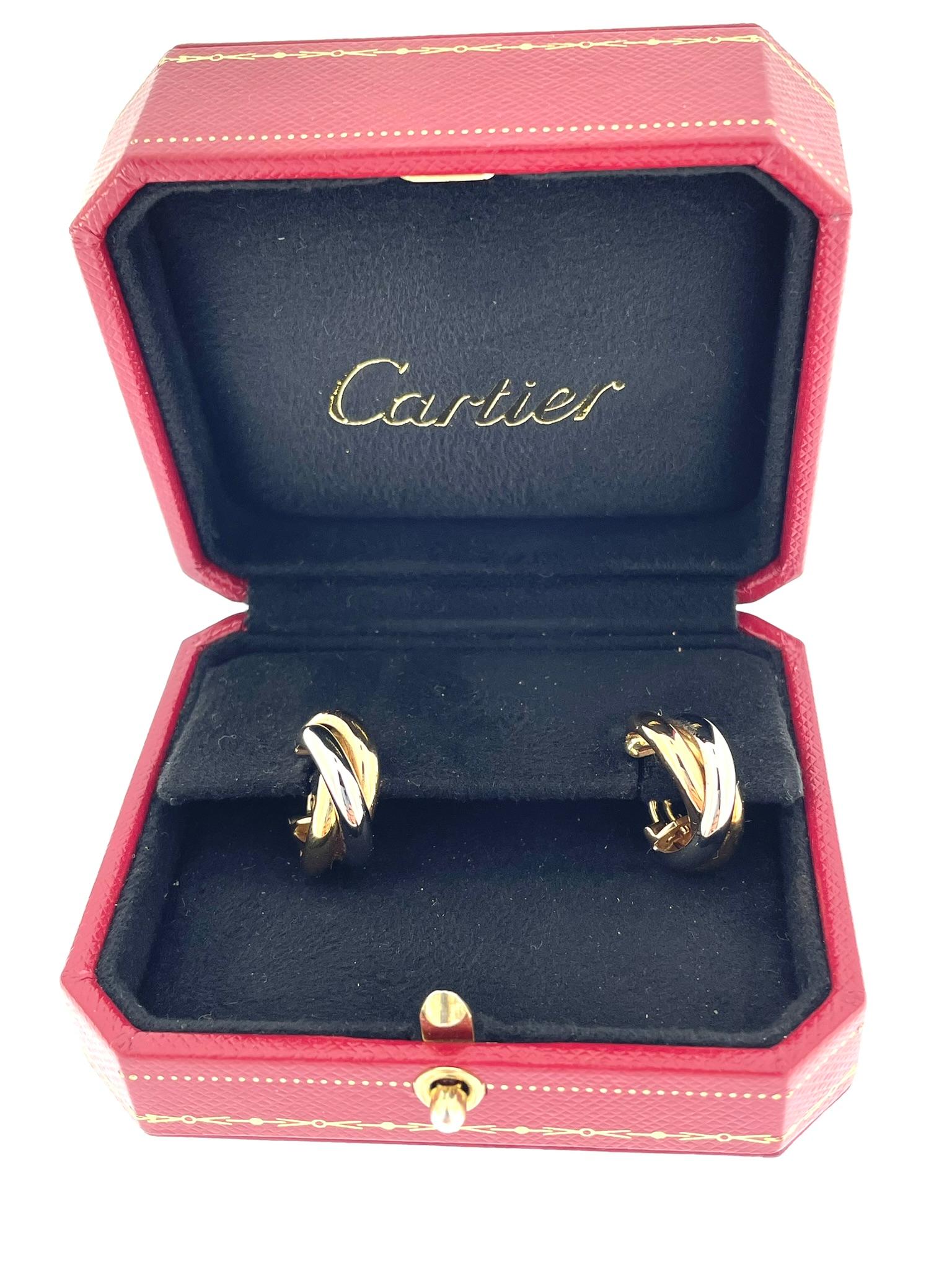The Cartier Trinity Earrings in 18-karat gold are a luxurious and iconic accessory crafted by the renowned French jewelry house, Cartier. These earrings are part of the Trinity de Cartier collection, which is known for its timeless and symbolic