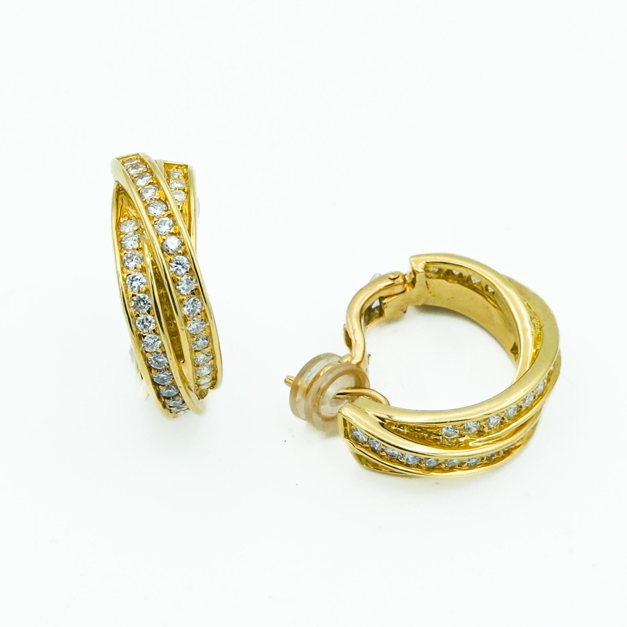 These 18 karat gold Cartier Trinity earrings are a blend of elegance and charm. Each earring features three interwoven bands, symbolizing love, fidelity, and friendship, all decked out with sparkly pave diamonds. The yellow gold really makes the