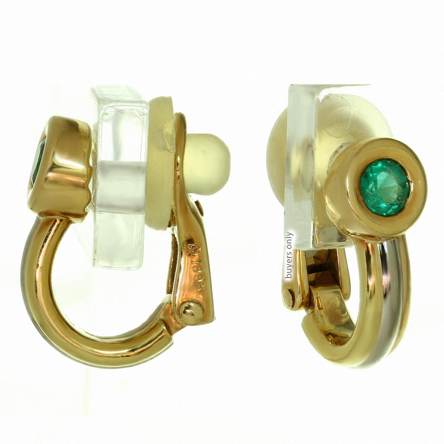 These gorgeous Cartier earrings from the classic Trinity collection are crafted in 18k yellow, white, and rose gold and set with round faceted sparkling bright green emeralds. Made in France circa 1980s. Measurements: 0.23