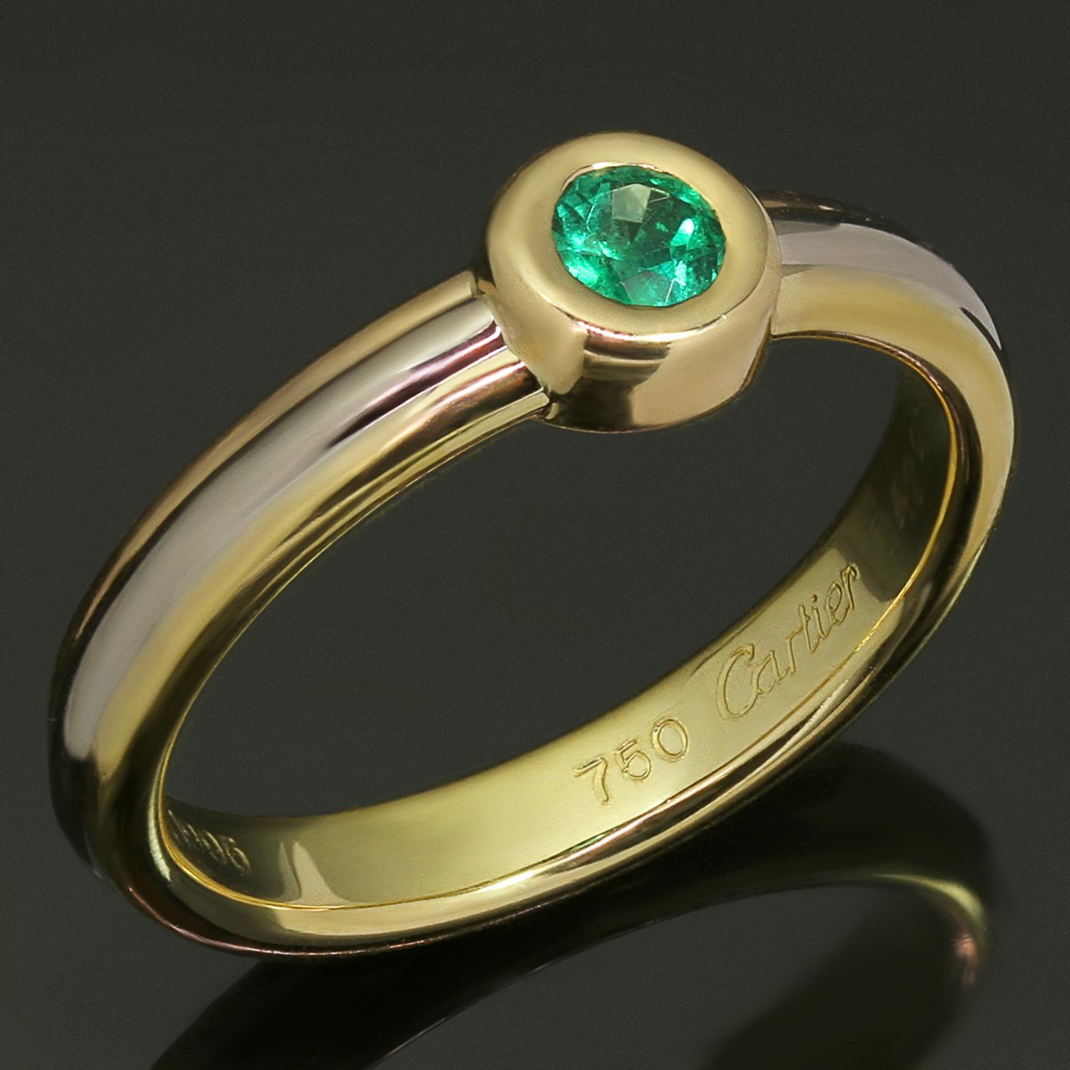 This chic Cartier ring from the iconic Trinity collection is crafted in 18k yellow, white, and rose gold and bezel-set with a round faceted emerald. Made in France circa 1995. Measurements: 0.23