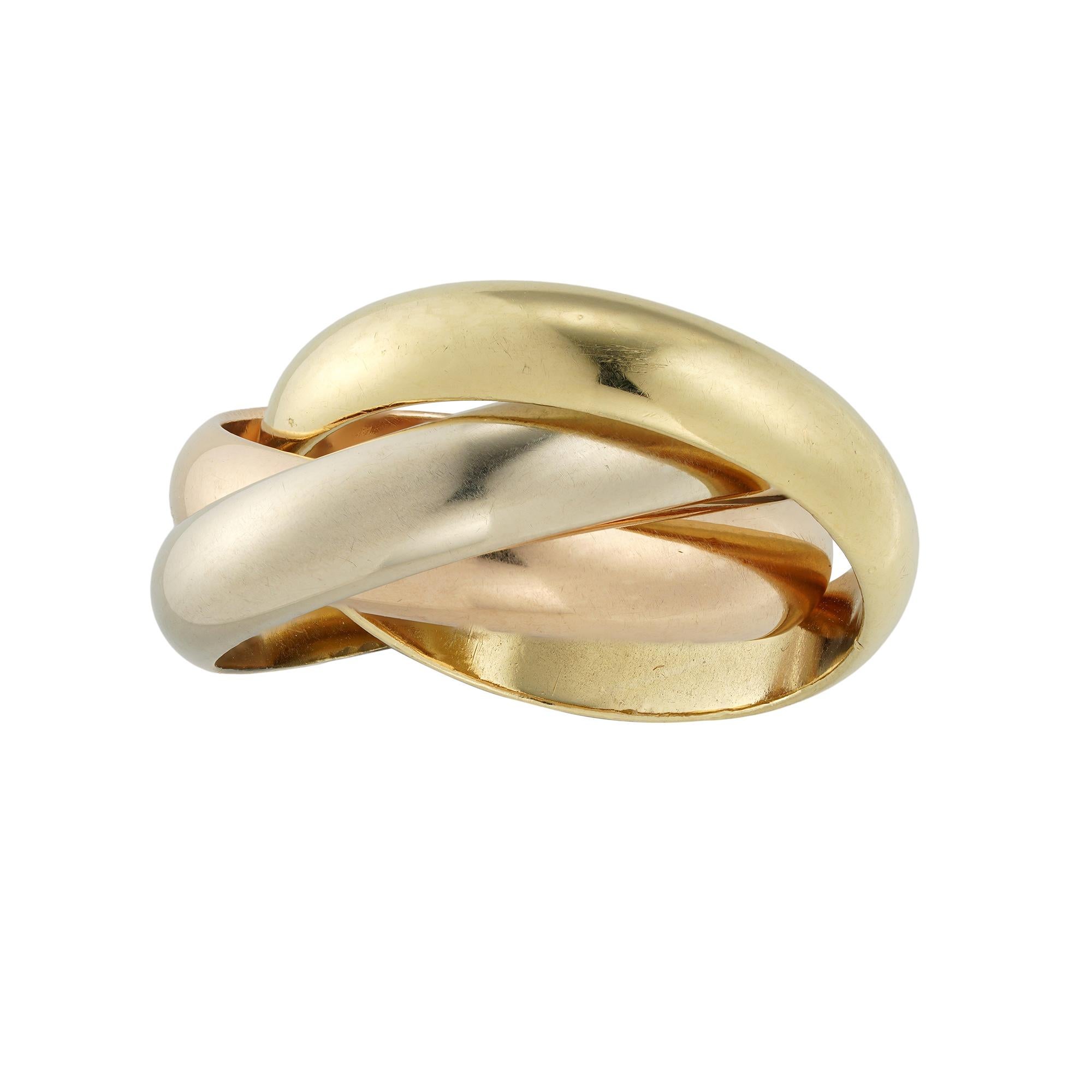 A Cartier Trinity wedding ring, with three bands in white, rose and yellow 18ct gold, each band measuring 4.1mm, signed Cartier, 750, 1997, finger size J 1/2, gross weight 13.9 grams.

This Cartier trinity ring is in very good condition.

This