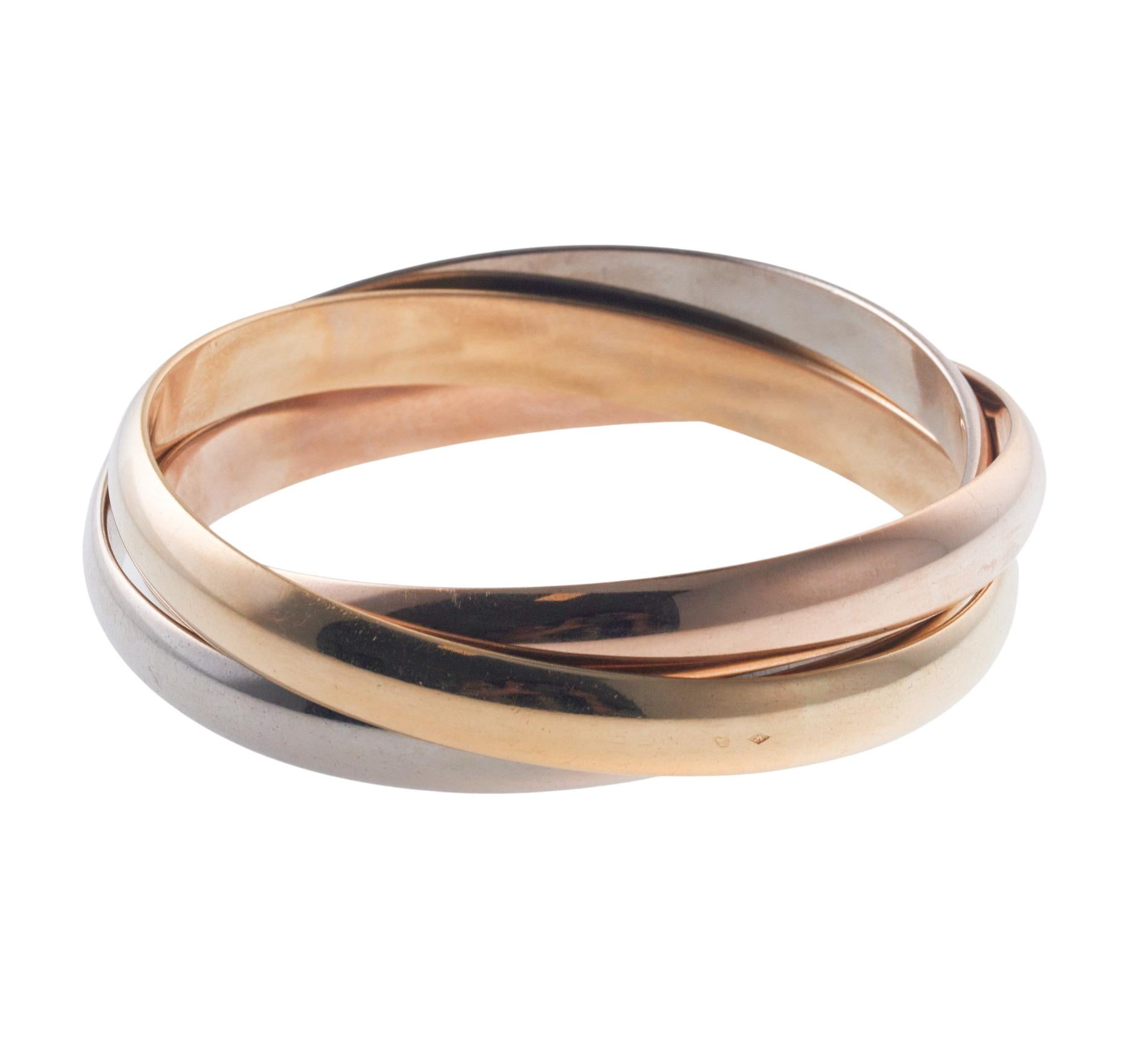 Cartier Trinity collection large model bangle bracelet in 18k gold. Bracelet will fit approx. 7