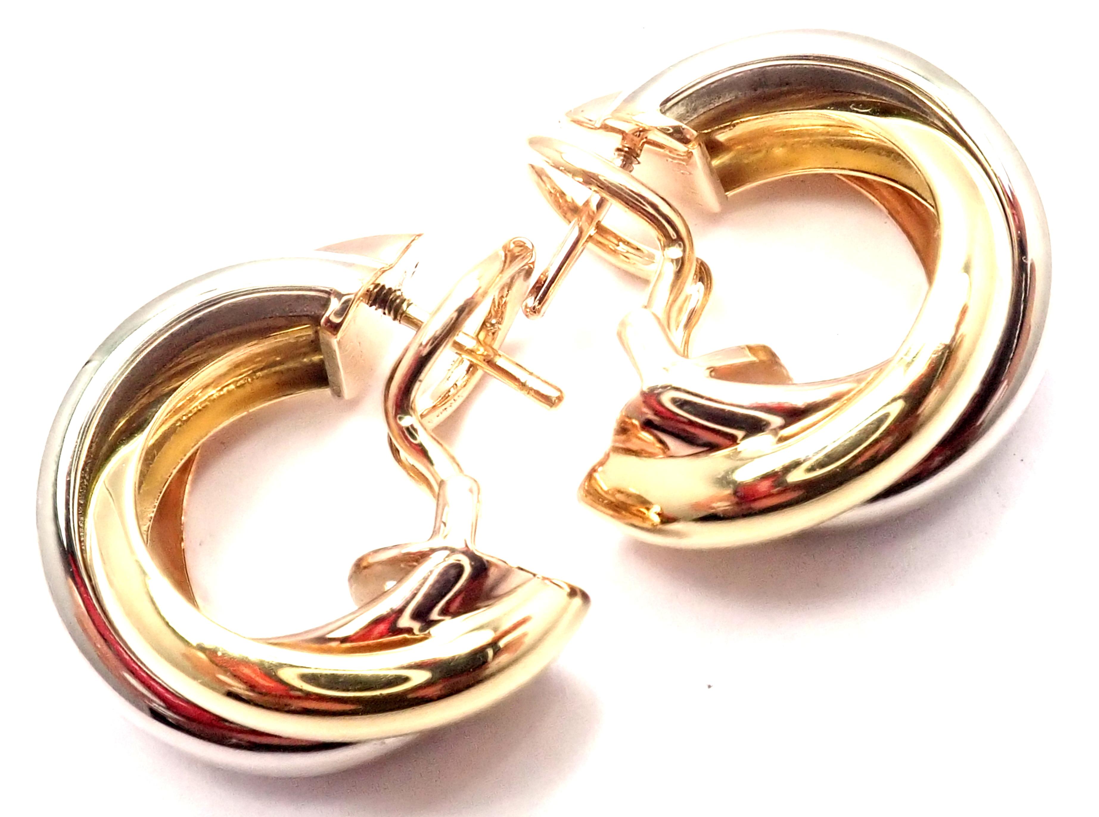 18k Tri-Color (Yellow, White, Rose) Gold Trinity Hoop Earrings by Cartier. 
These earrings are for pierced ears.
Details: 
Measurements: 19mm x 8mm
Weight: 8.7 grams
Stamped Hallmarks: Cartier 750 DXXXXX(serial number available for buyers) French