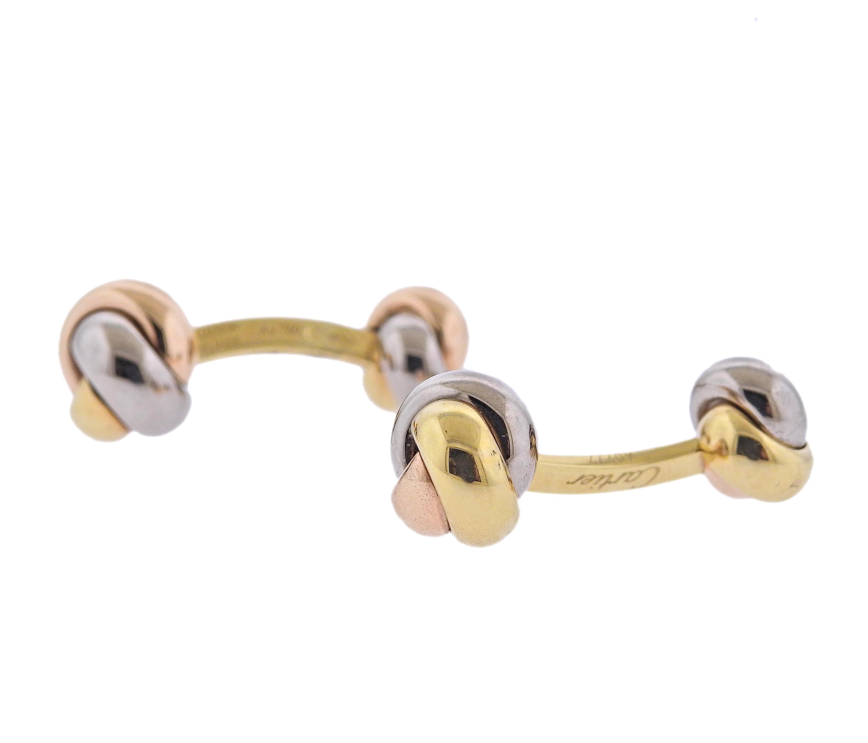 Pair of classic 18k white, yellow and rose gold Trinity cufflinks by Cartier. Each top is 13mm x 13mm, back - 10 x 9mm. Marked: Cartier, 750, A0777, made in France. Weight - 11.7 grams.