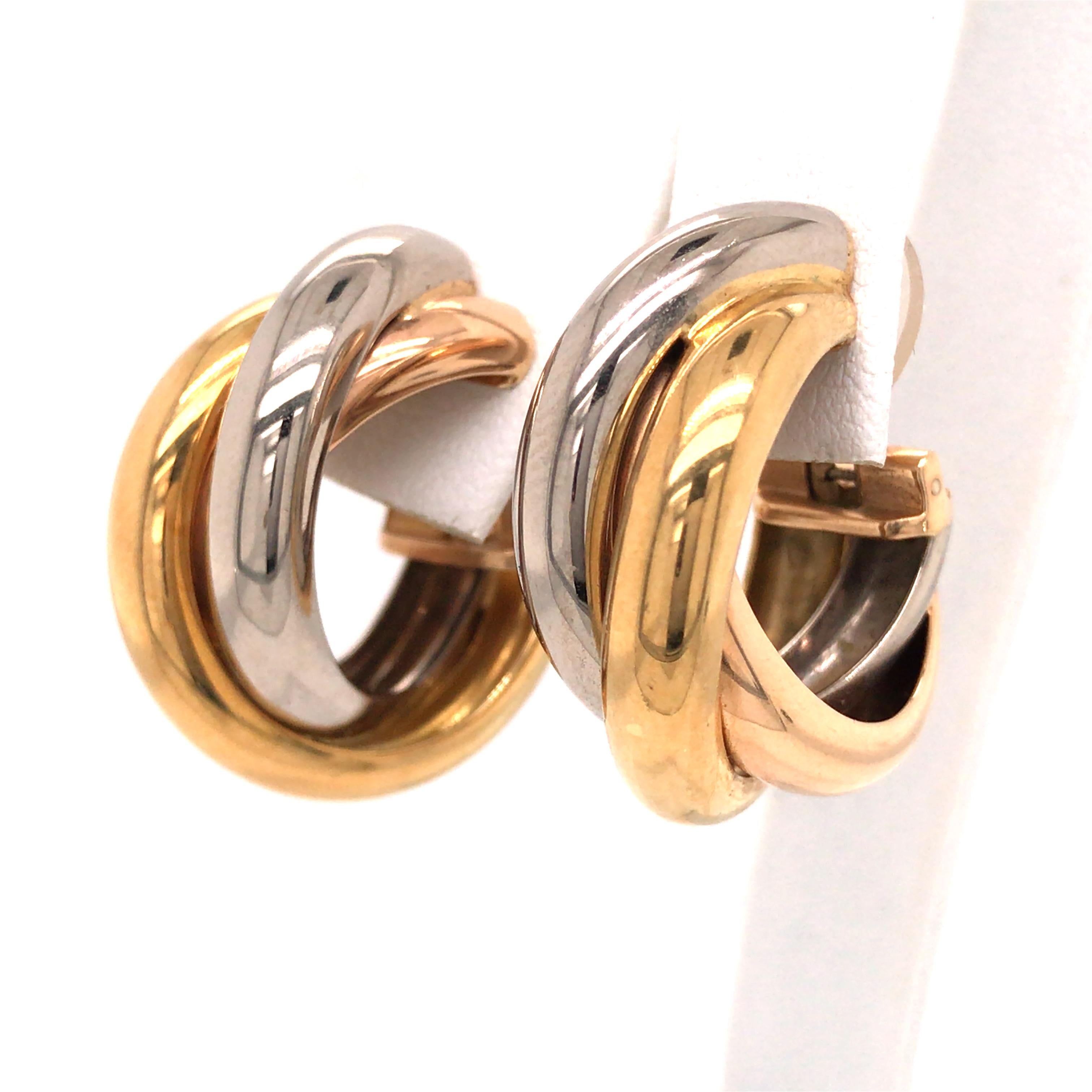 Cartier Trinity Large 18K Tri-Color Gold Hoop Earrings.  The Earrings measure 1 inch in length and 3/8 inch in width.  Clip on/off closure. 14.46 grams. Signed, 750, serial number.