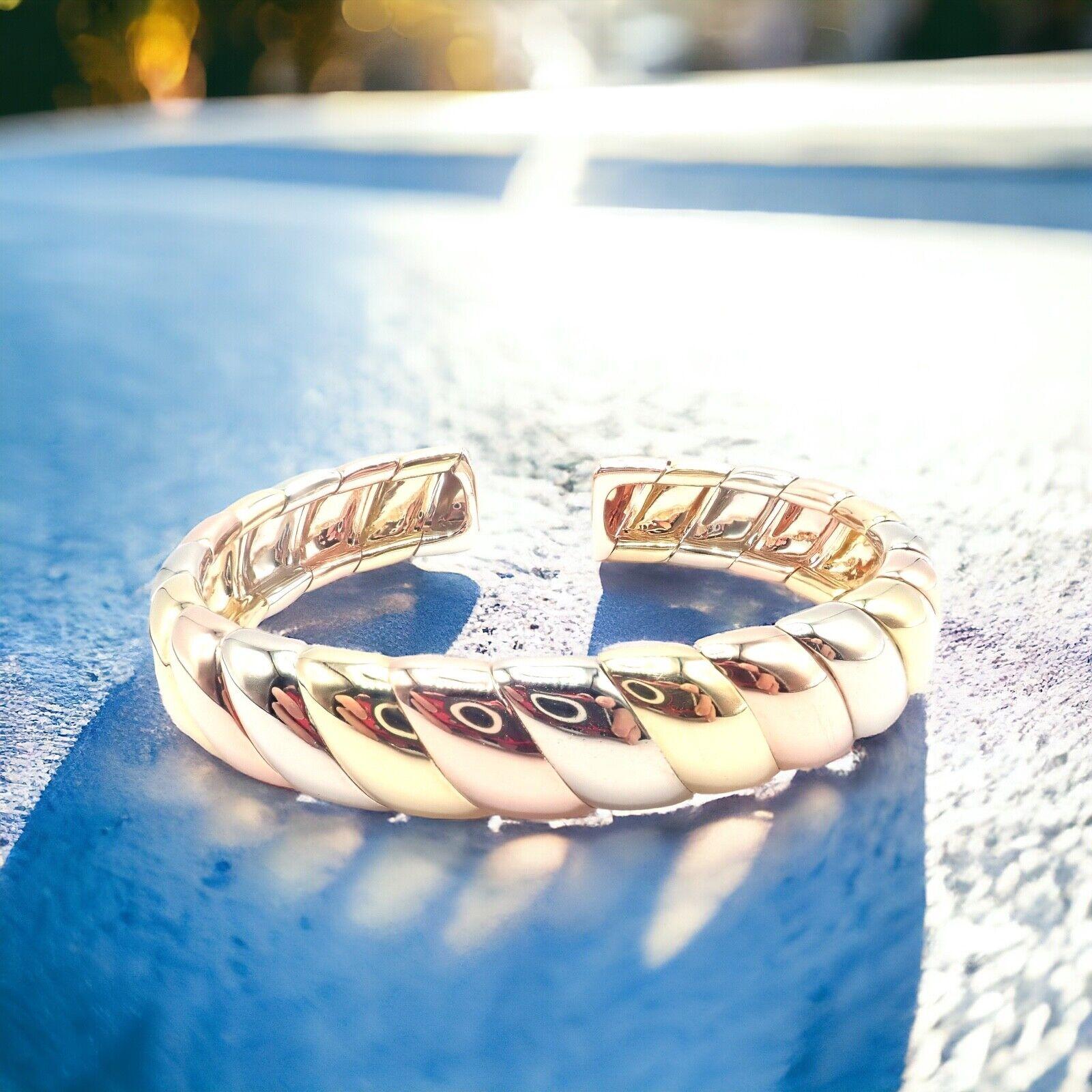 18k Tri-Color Gold Trinity Cuff Bangle Bracelet by Cartier.
The Cartier Trinity cuff bangle is an iconic piece, elegantly crafted from 18k multi-color gold. 
This exquisite bracelet intertwines yellow, white, and rose gold bands, symbolizing love,