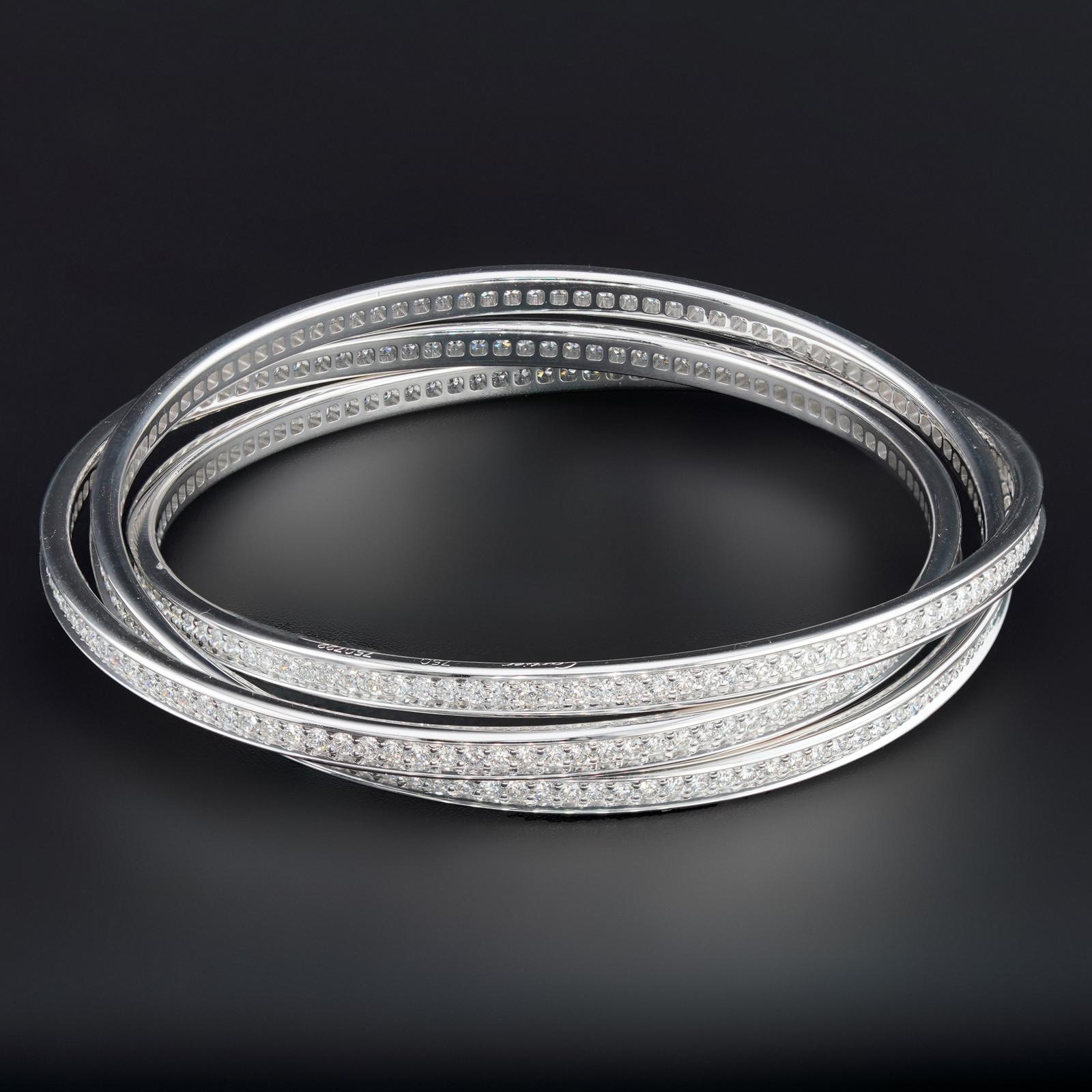 This gorgeous Cartier bracelet from the iconic Trinity collection features 3 interconnected bangles made in 18k white gold and set with brilliant-cut round D-E-F VVS1-VVS2 diamonds. Fits small wrist measuring 6.5 to 7 inches. Made in France circa