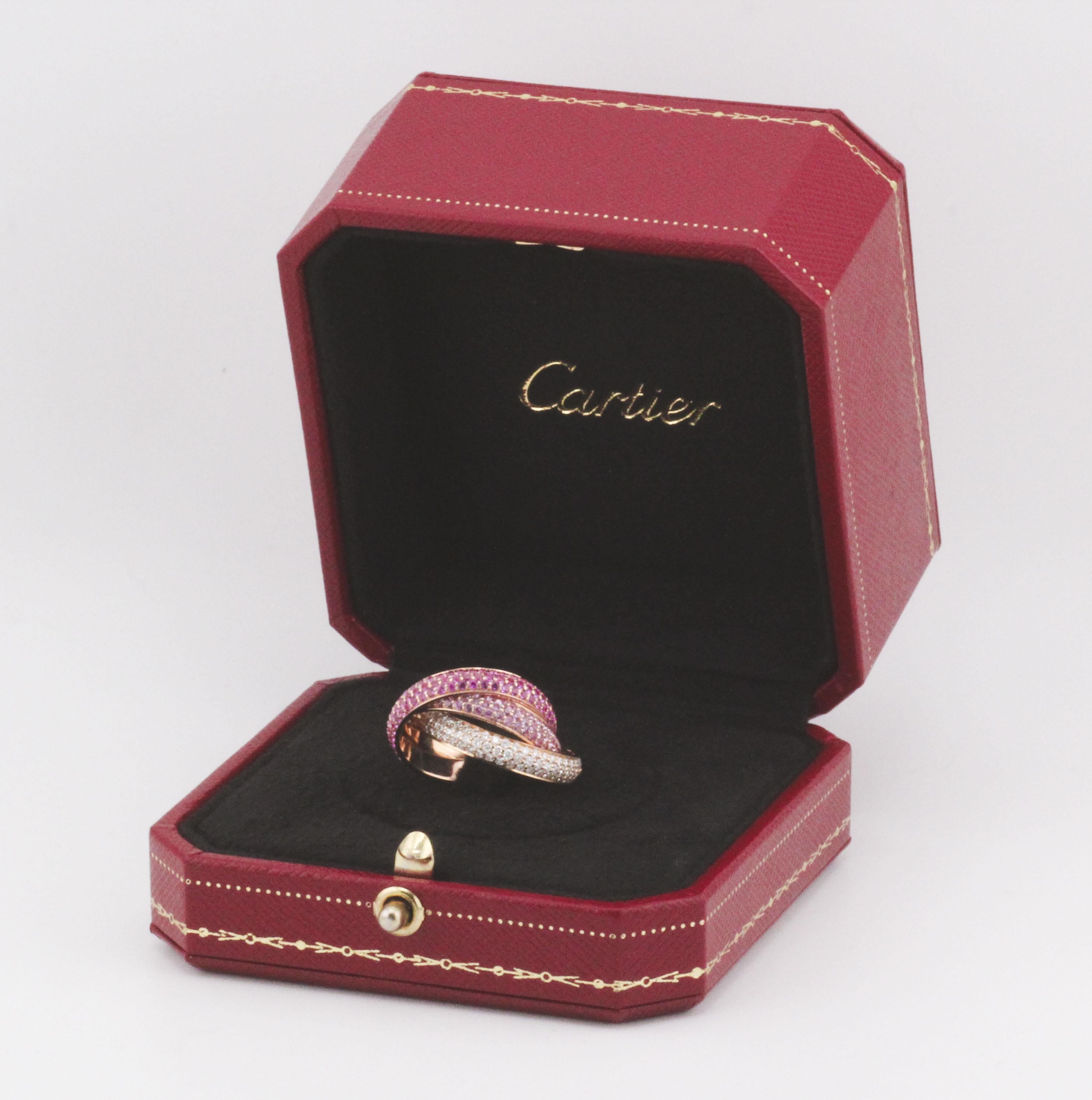 The Cartier Trinity Pink Sapphire Ruby Diamond 18K Rose Gold Band is an exquisite piece of jewelry that seamlessly blends elegance with vibrancy. Crafted by the renowned luxury brand Cartier, this band is a testament to impeccable craftsmanship and