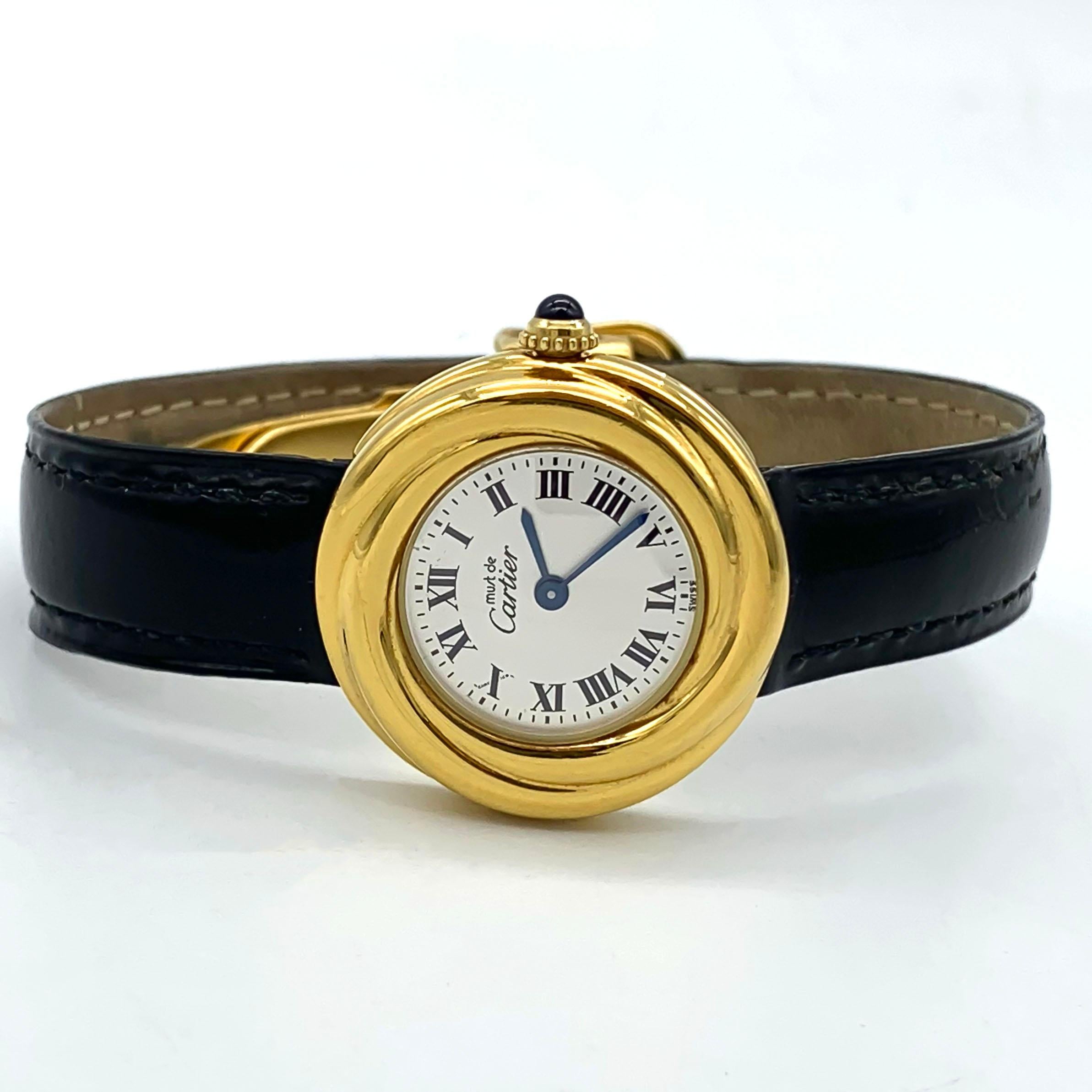 The Cartier Trinity Vermeil Must De Cartier 925 Silver  Ref. W1010644 2735 is a stunning women's wristwatch that combines timeless elegance with modern functionality. Crafted by the renowned luxury brand Cartier, it features a sleek silver case with