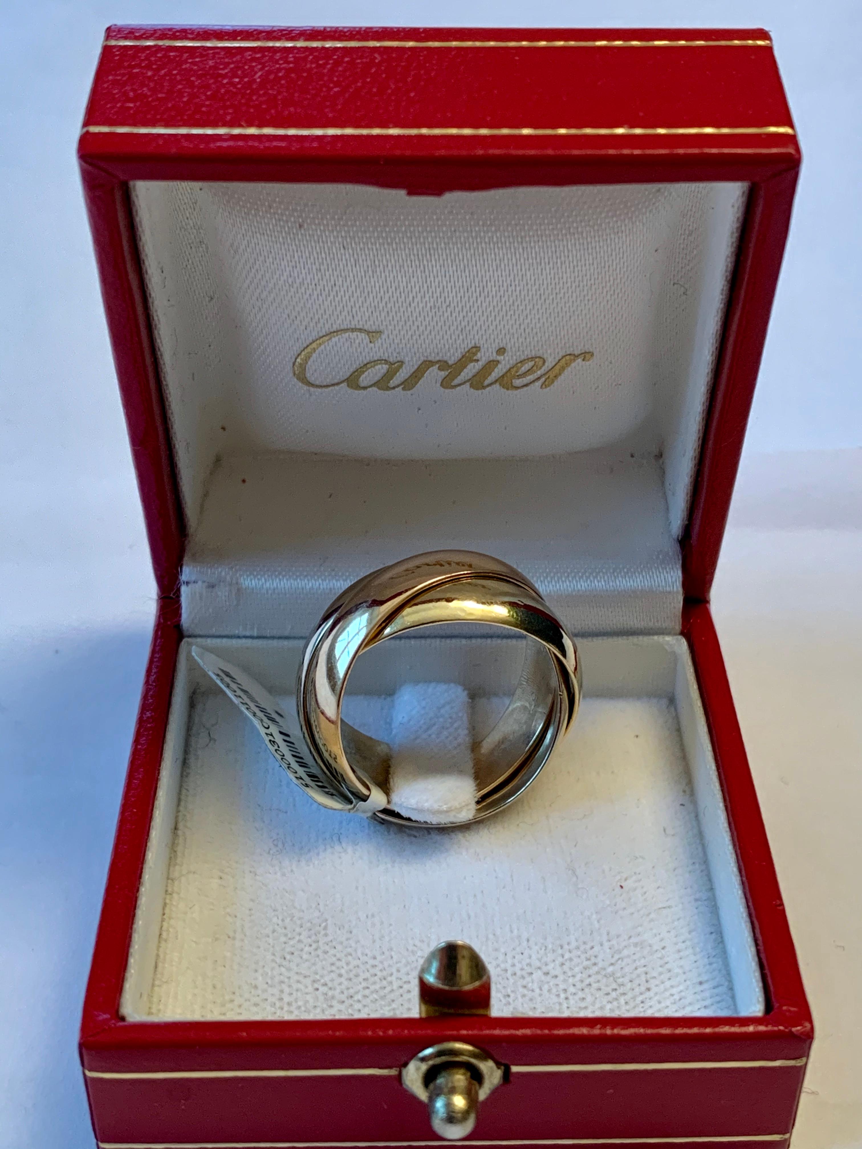 We guarantee this is an authentic CARTIER 18K Pink Yellow White Gold Large Trinity Ring 57 8 . This stunning ring is a criss cross band of 18 karat pink, yellow, and white gold. This is a beautiful ring with the classical style only from Cartier!