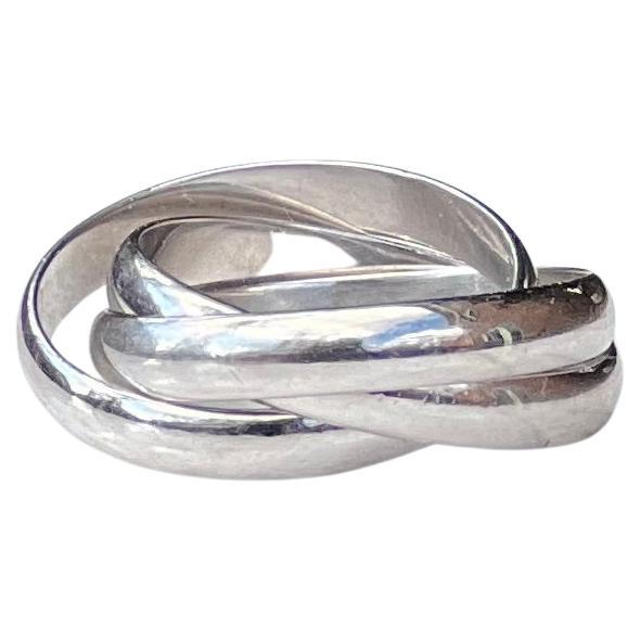 One 18 karat white gold trinity by Cartier consisting of three intertwined 3.5mm half round bands.  The ring weighs 8.6 grams and is a finger size 7. 

Love. Fidelity. Friendship. Conceived by Louis Cartier in 1924, the Trinity collection has become