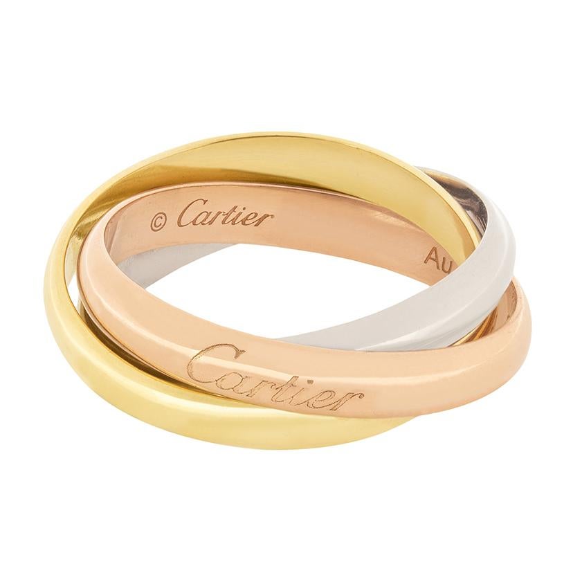 This Cartier ring is from their ‘Trinity’ collection. Three interlocking gold bands form the ring, one is made of 18 carat yellow gold, 18 carat white gold, and 18 carat rose gold.  All the original ‘Cartier’ makers marks are visible around the