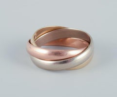 Cartier "Trinity" ring in 18 karat gold, white gold, and rose gold.