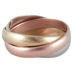 Vintage Cartier "Trinity" ring in 18 karat gold, white gold, and rose gold. 