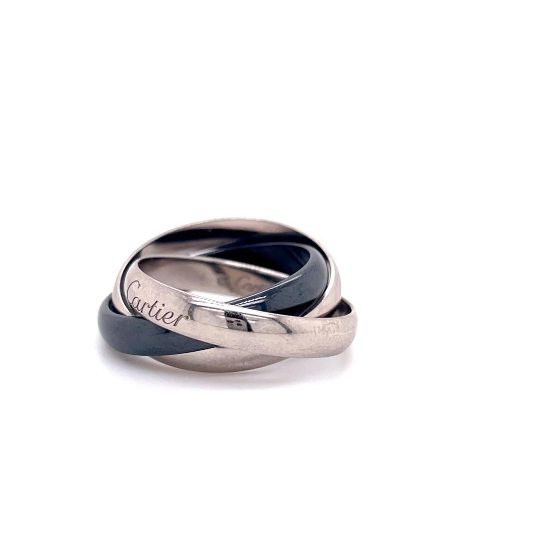 A Cartier Trinity ring set in 18 karat white gold and black ceramic

This timeless ring comprises of three seamlessly interlinked 3.2 millimetre bands that are designed to roll with ease on the finger of the wearer. 
The trinity ring is a classic