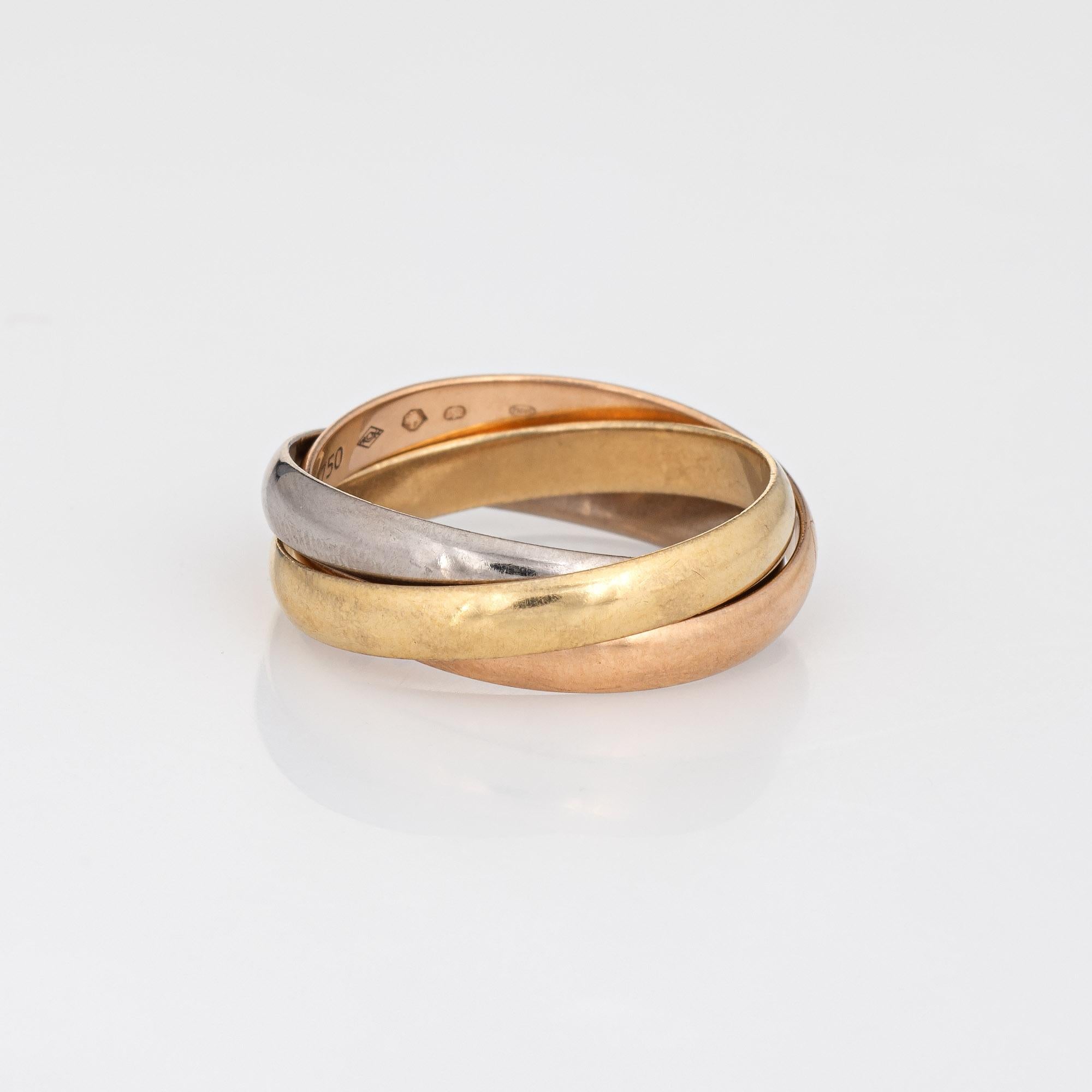Pre owned Cartier Trinity ring crafted in 18k yellow, white & rose gold.  

The Cartier ring features bands of 18k rose, yellow & white gold. Each band measures 2.8mm wide. The ring is great worn alone or layered with your fine jewelry from any era.