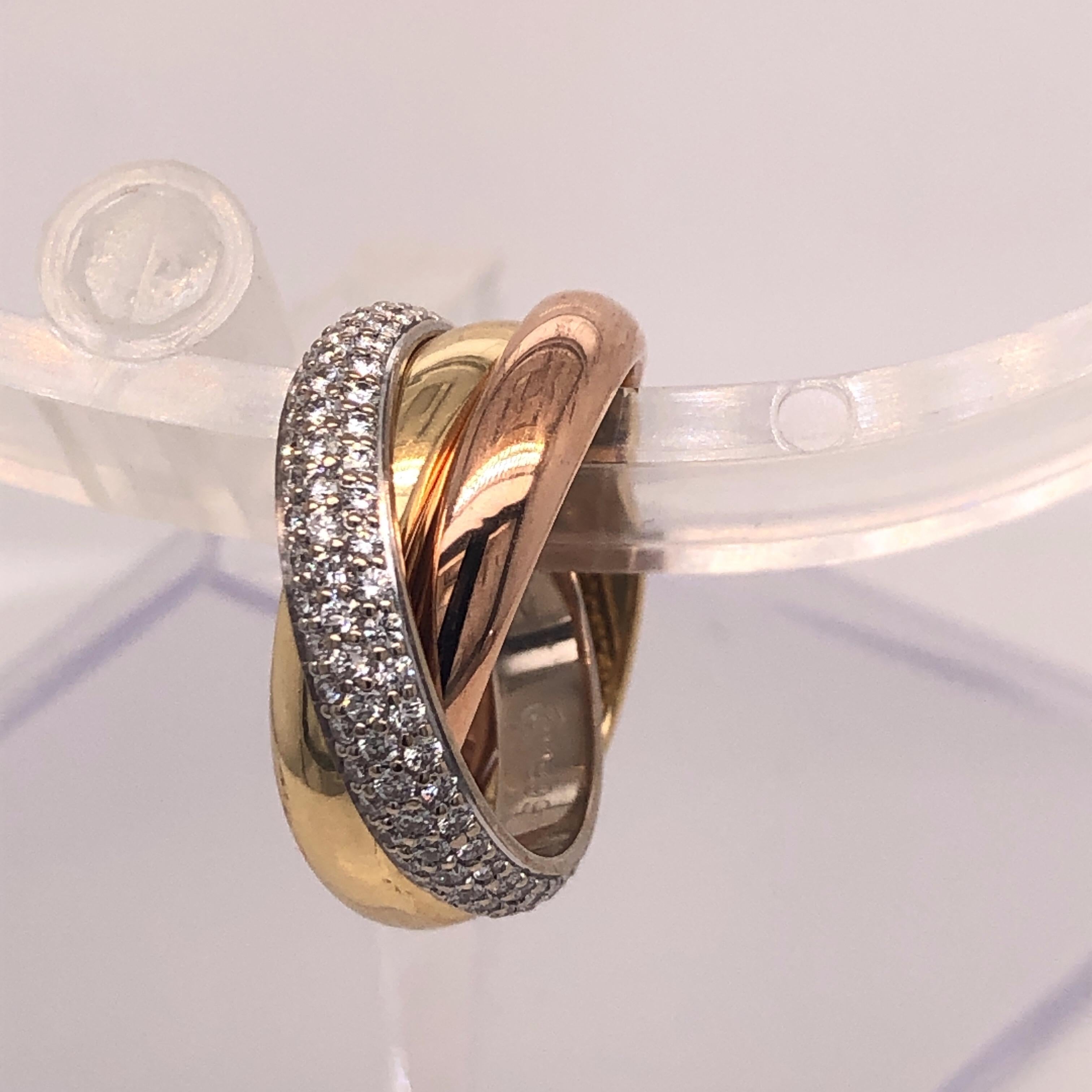 Cartier Trinity Ring with Pave Diamonds 18K White, Yellow and Rose Gold.   Size 4.5 and cannot be sized.  Mint Condition with Box and Papers.  Stamped Cartier. 