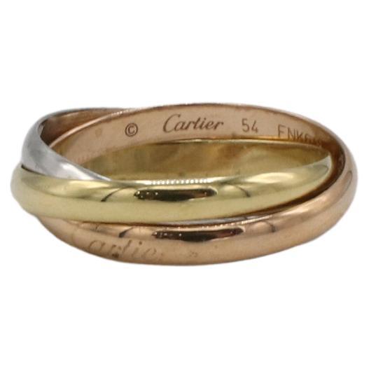 Cartier Trinity Small Model Rolling Tri-Color 18 Karat Gold Band Ring Box & Papers 
Metal: 18 karat yellow, white rose gold
Weight: 4.72 grams
Width: One ring is 2.5mm
Size: 54 (7.25 US)
Retail: $1,420 USD
Note: Box & papers 
SRN I-15250

