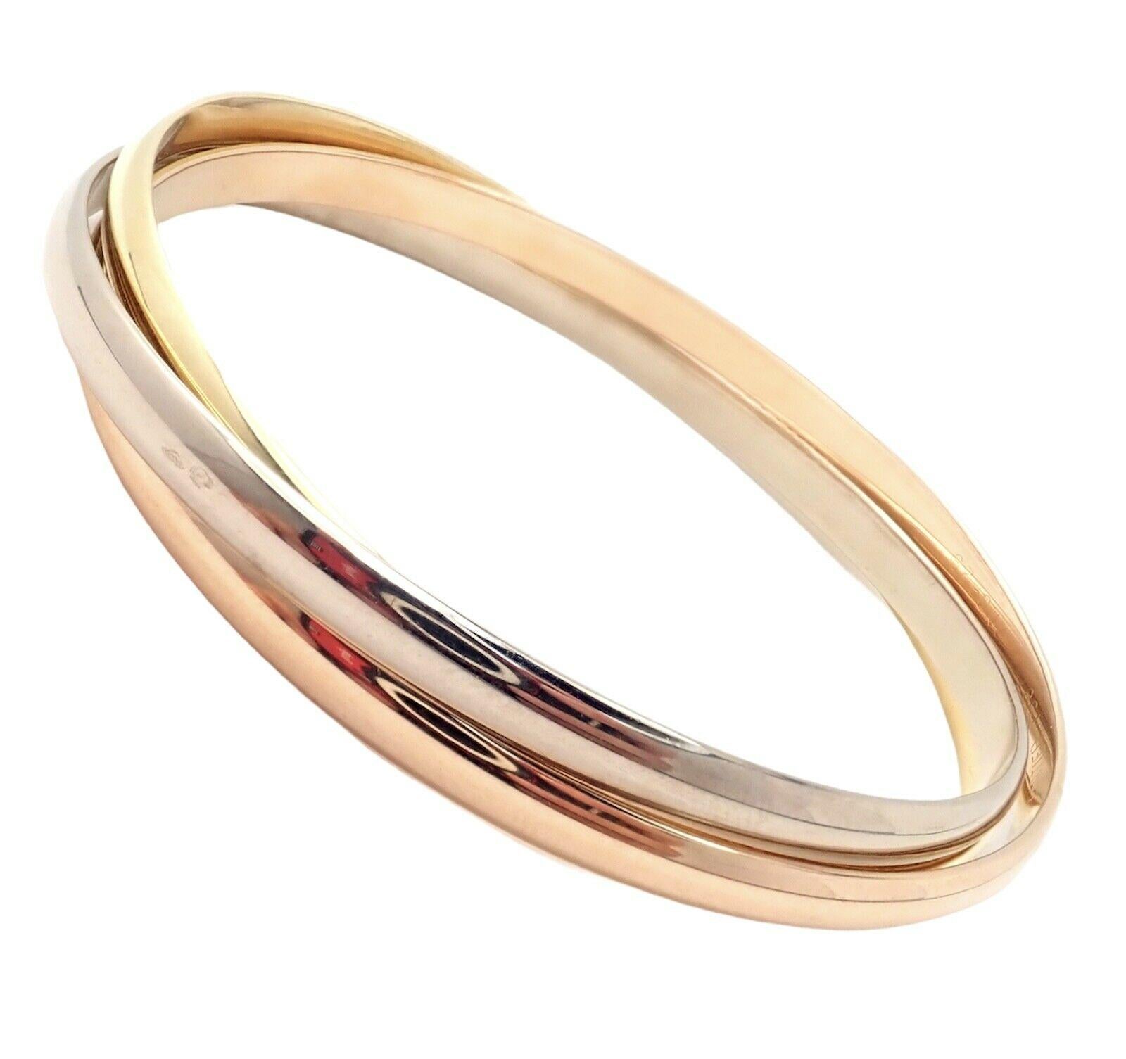 18k Tri-Colored Gold (Yellow, White, Rose) Trinity Rolling Bangle Bracelet by Cartier. 
Details: 
Length: 7 3/4