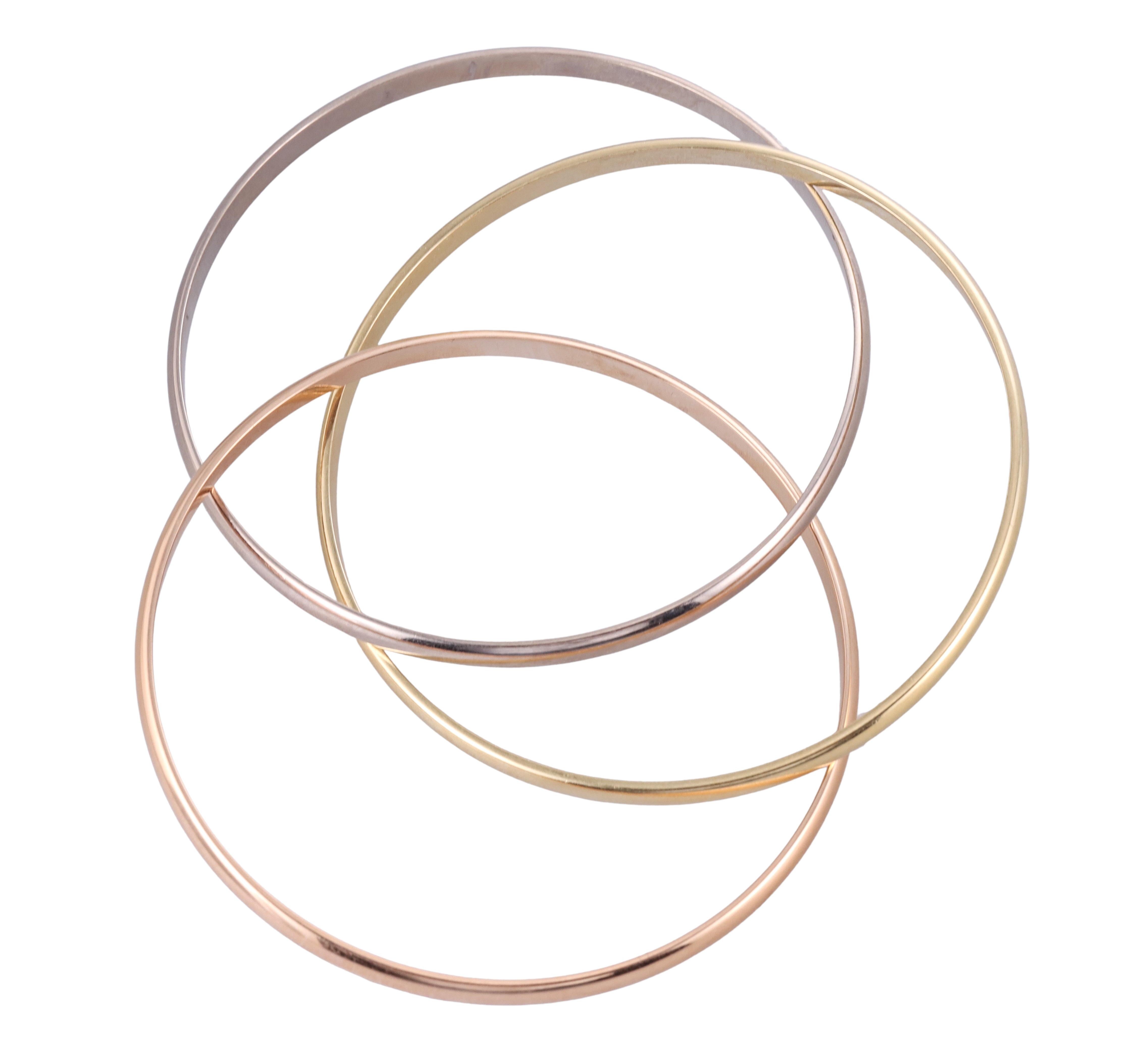 Iconic Trinity bangle bracelet by Cartier, set in traditional 18k rose, white and yellow color gold. Bracelet will fit an approximately 7