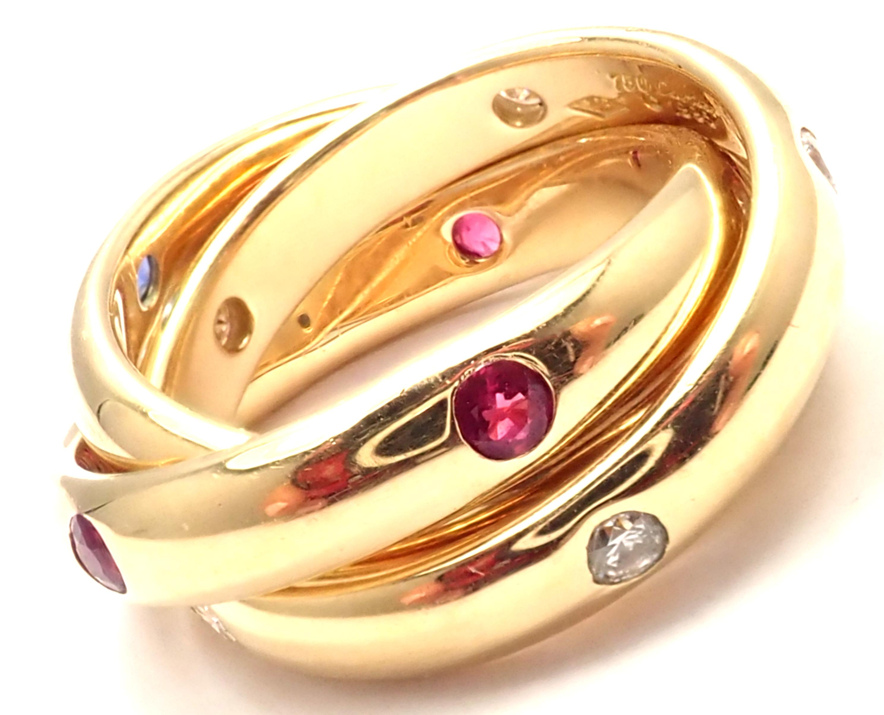 18k Yellow Gold Diamond Ruby Sapphire Trinity Band Ring by Cartier. 
With 6 round brilliant cut diamonds VS1 clarity, G color total weight approx. .18ct 6 rubies & 6 sapphires
Details: 
Size: European 49 US 4 3/4
Width: Single Band Width: 4mm; Total