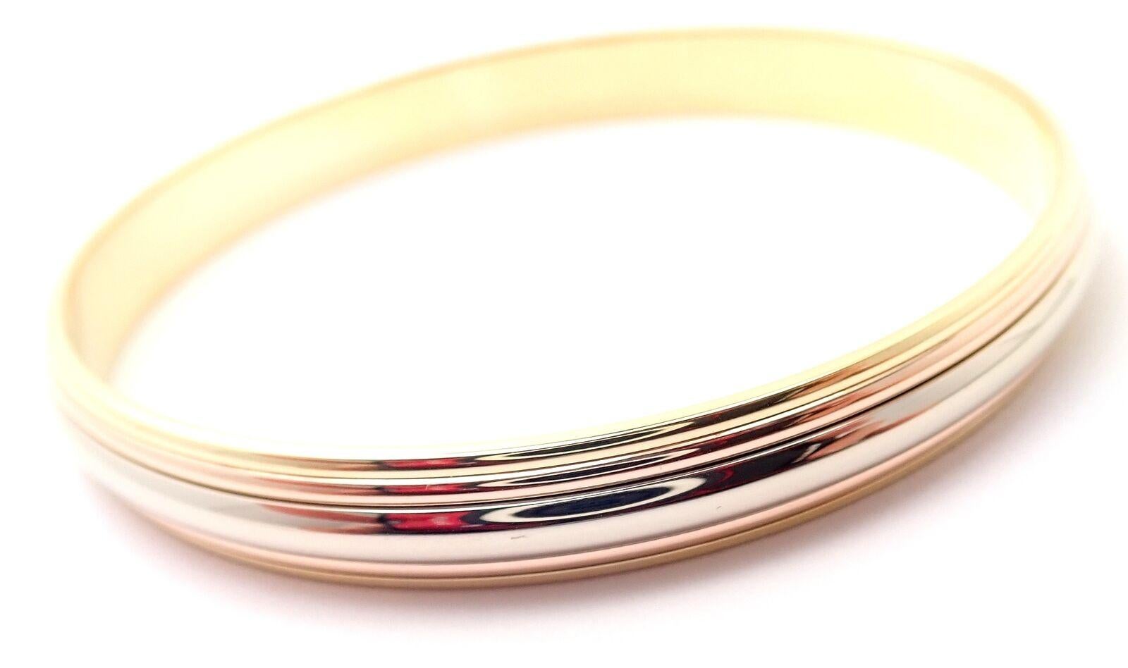 18k Tri-Colored Gold (Yellow, White, Rose) Trinity Slip-On Bangle Bracelet by Cartier. 
Details: 
Length: Size 6.5