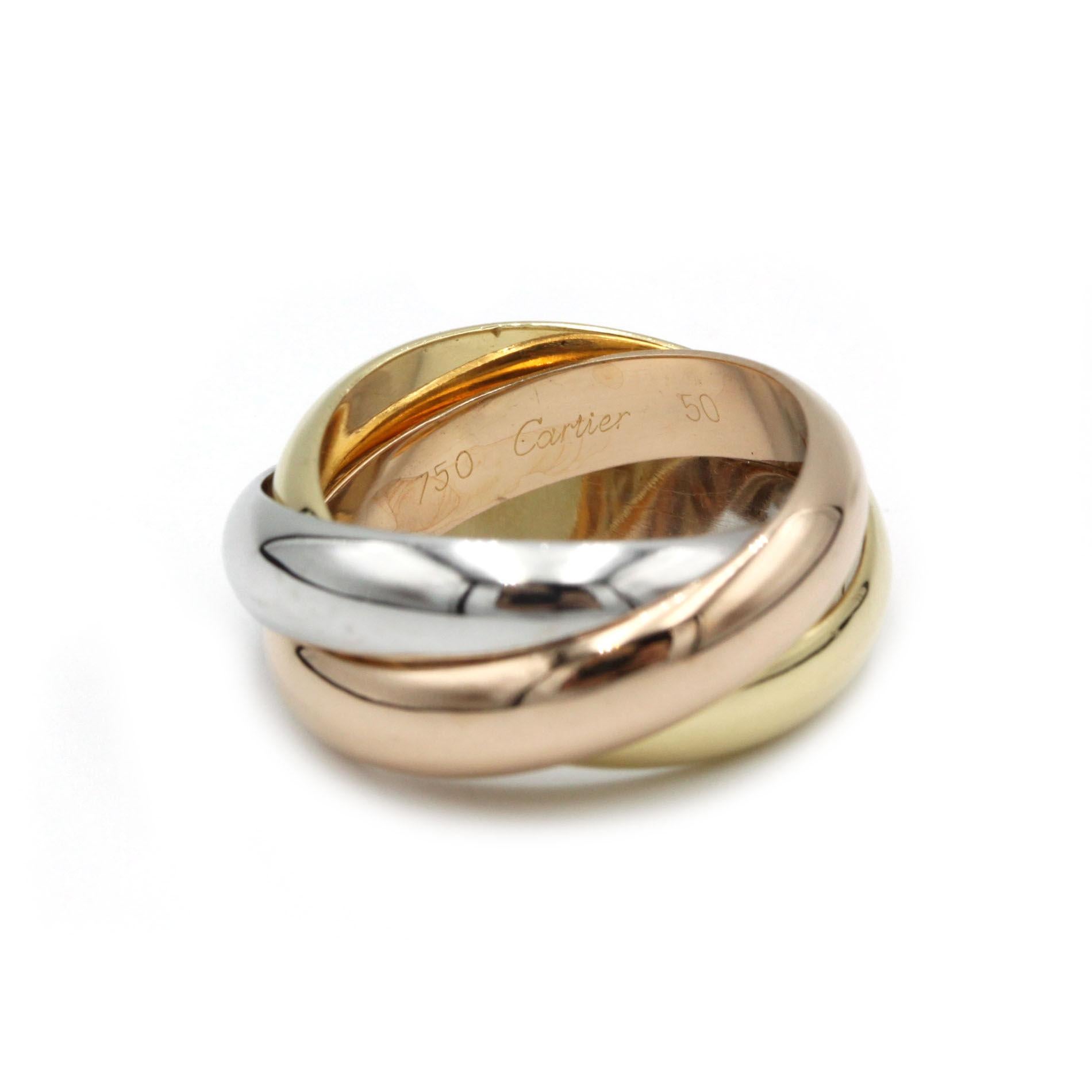 An enduring icon from Cartier’s Maison, this “Trinity” ring artfully interlocks three gently curved bands—one each of polished 18K yellow, white and rose gold—into a seamless rolling motif. Crafted in France and hallmarked inside with “750 Cartier,”