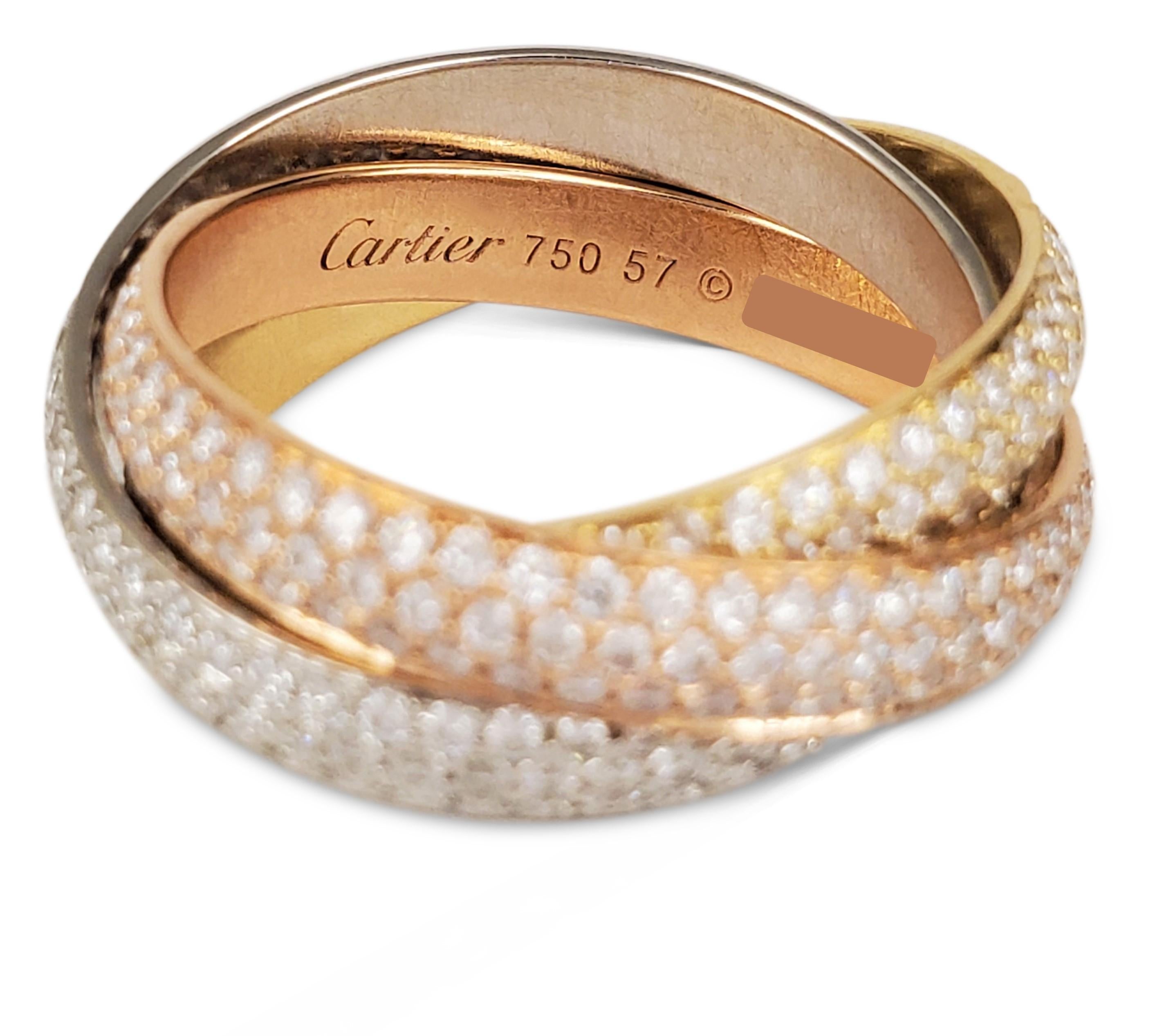 Authentic Cartier 'Trinity' ring comprised of three interlocking mobile bands of 18 karat yellow, rose, and white gold. Each ring is encrusted with pave set high-quality round brilliant cut diamonds of an estimated 2.98 carats. Signed Cartier, 750,
