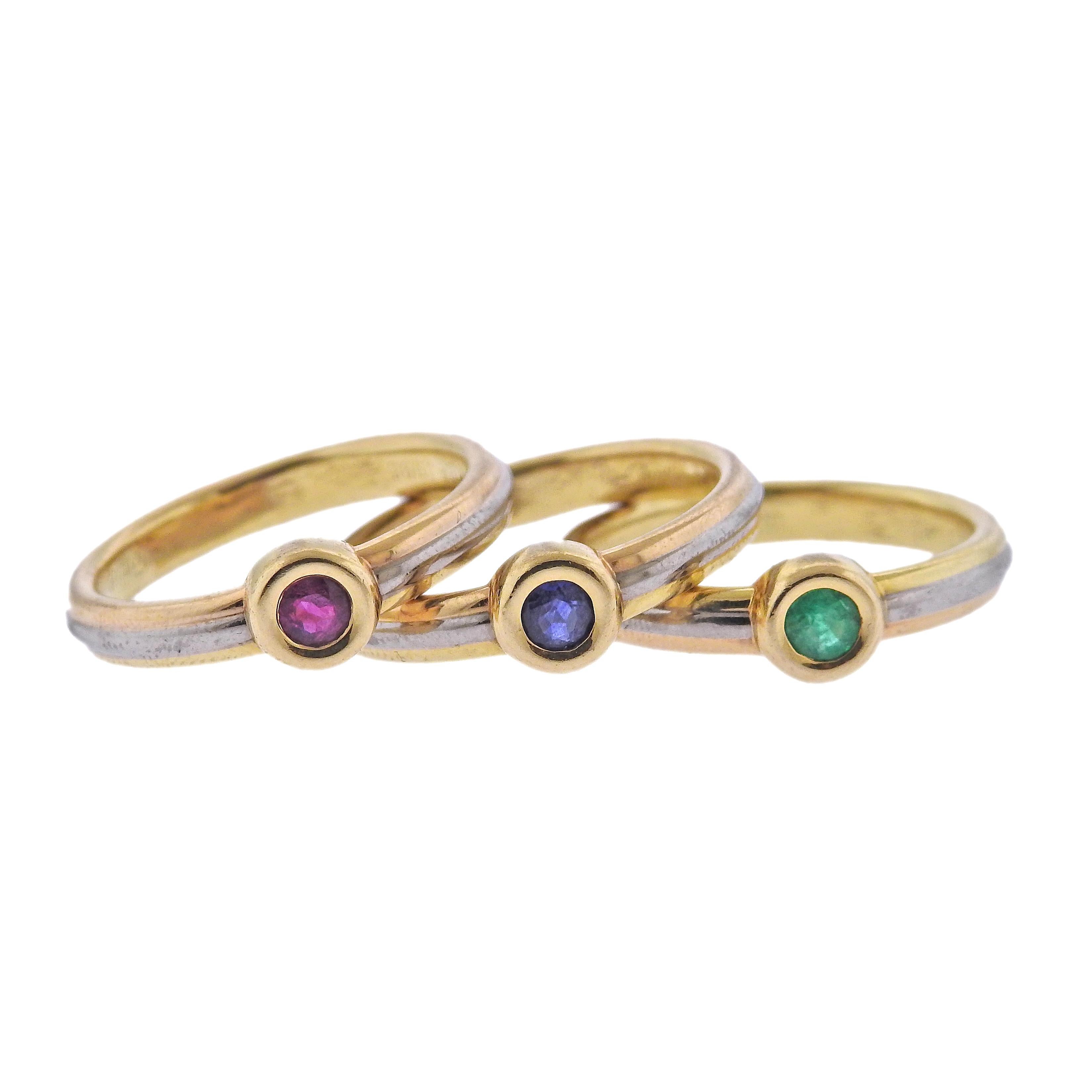 Set of three 18k gold Trinity Cartier rings, each set with a gemstone - ruby, sapphire and emerald.  Each ring is size 8, top is 6mm in diameter. Marked: Cartier, 55, 1995, D87729, E78564, D86890 (on each ring). Weight - 15.9 grams.