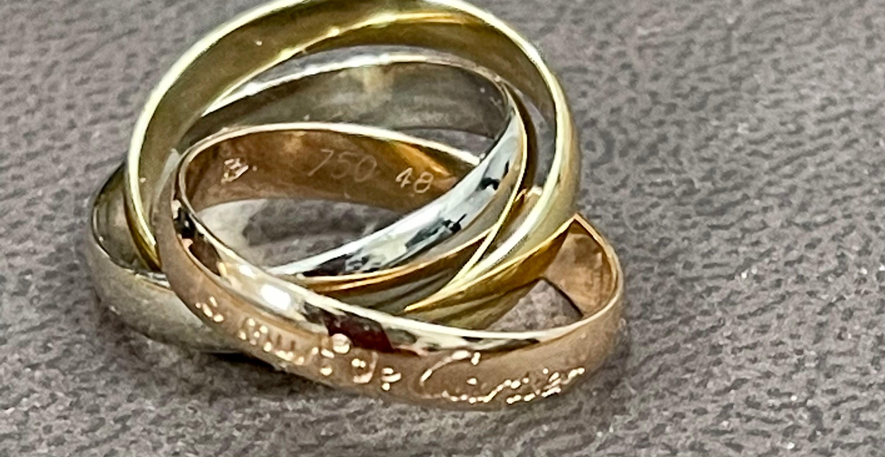 This Cartier Trinity Ring is the classic three band rolling ring. 
Cartier Trinity de Cartier Tri-Color 18k Gold Ring
Ring Size	4.5 , very small ring
Marked 750, 48
Materials	18k Yellow Gold, White Gold and Rose Gold
Measurements	Each ring is