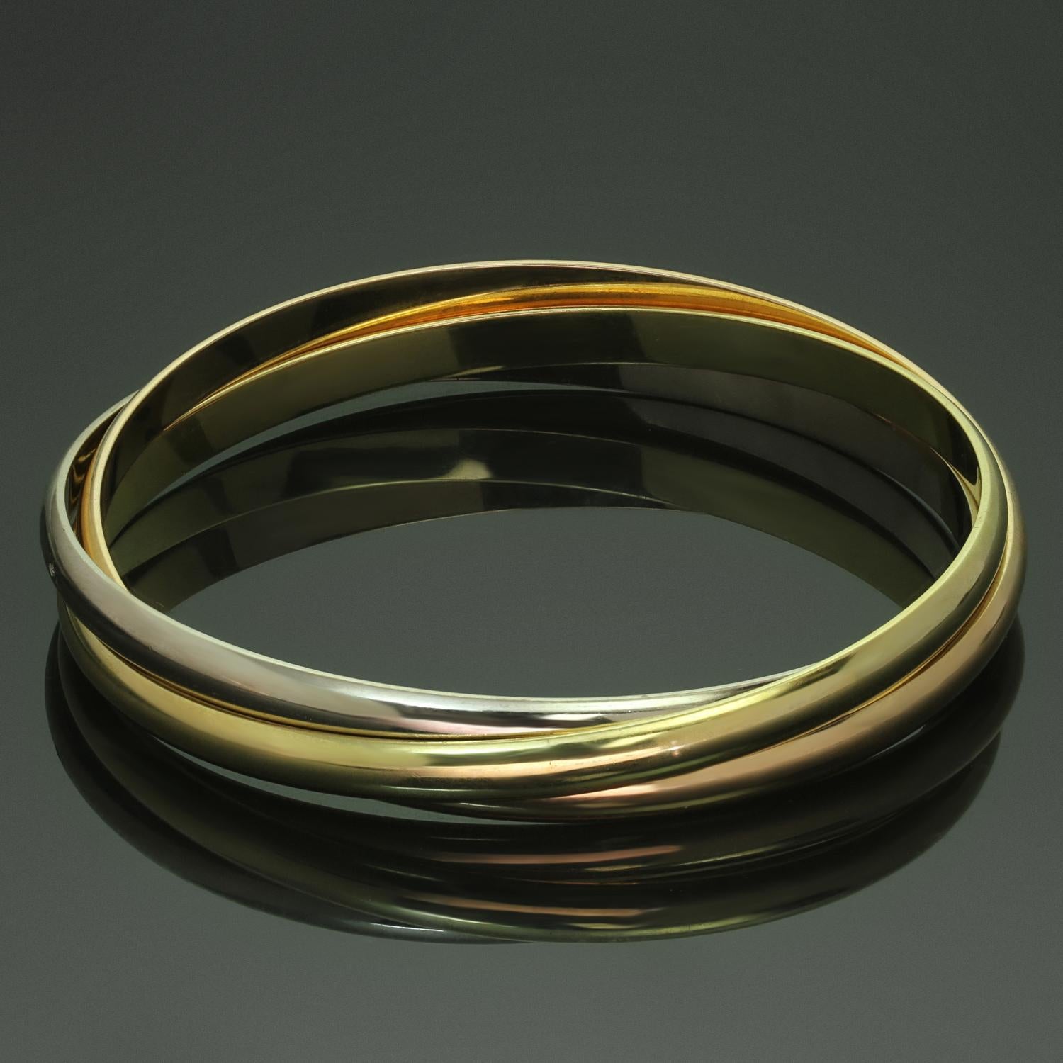 This gorgeous Cartier bracelet from the iconic Trinity collection features 3 interconnected bangles made in 18k yellow, white, and rose gold. Made in France circa 1997. Measurements: 6.25