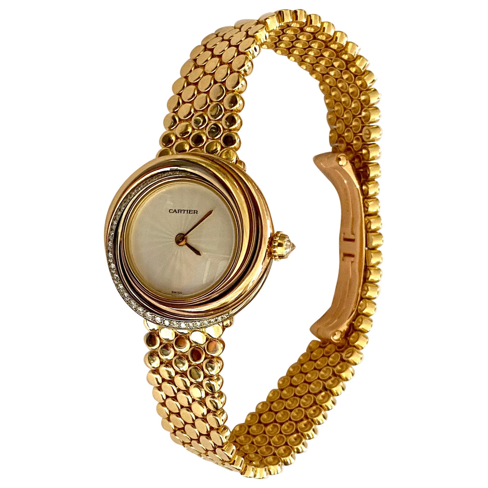 Cartier, Trinity Watch in 18 Karat Gold 33 Diamonds and a 18 Karat Gold Bracelet