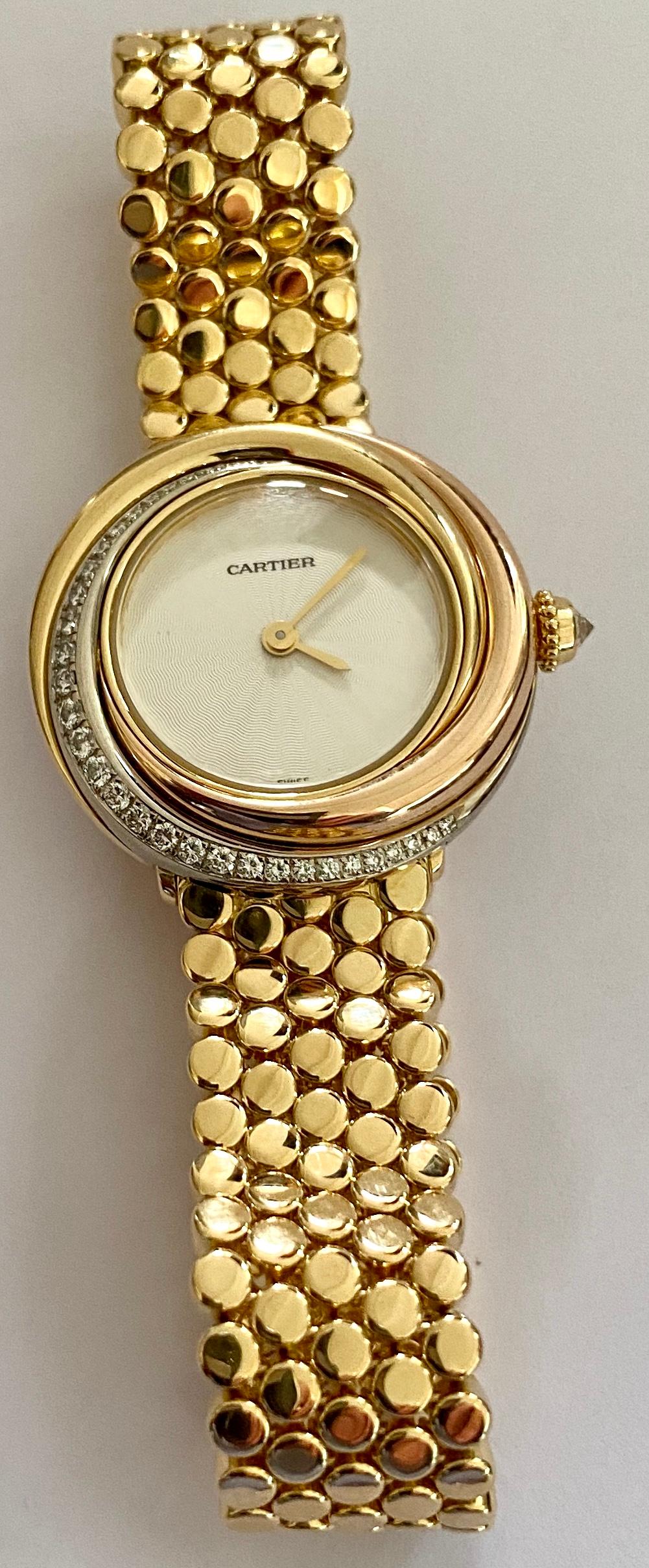 Cartier, Trinity Watch in 18 Karat Gold 33 Diamonds and a 18 Karat Gold Bracelet 1