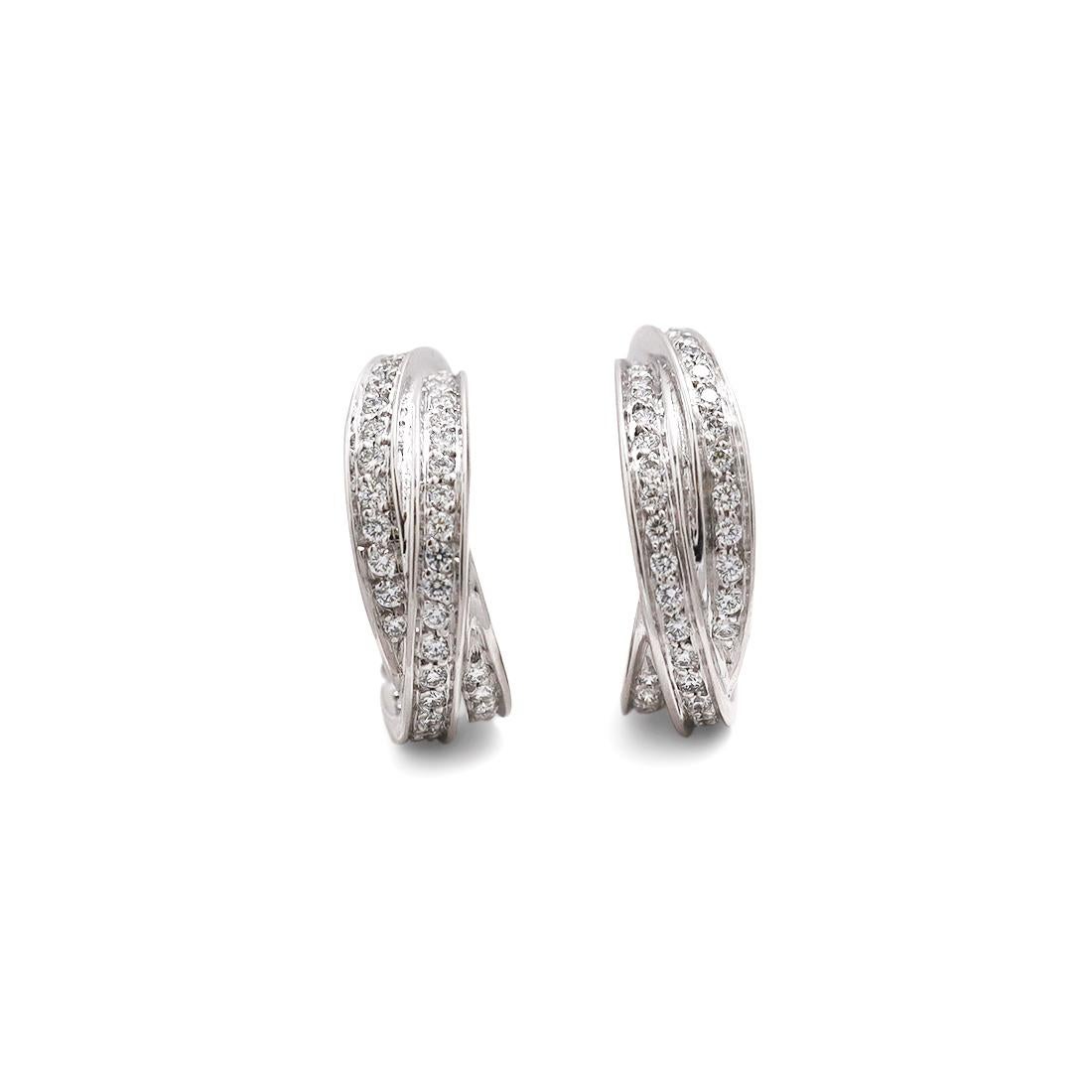 Authentic Cartier Trinity earrings crafted in 18 karat white gold. Comprised of a trio of interlocking bands set with round brilliant cut diamonds weighing approximately 1 carat for the pair. The earrings measure .96 inches in length and .26 inches