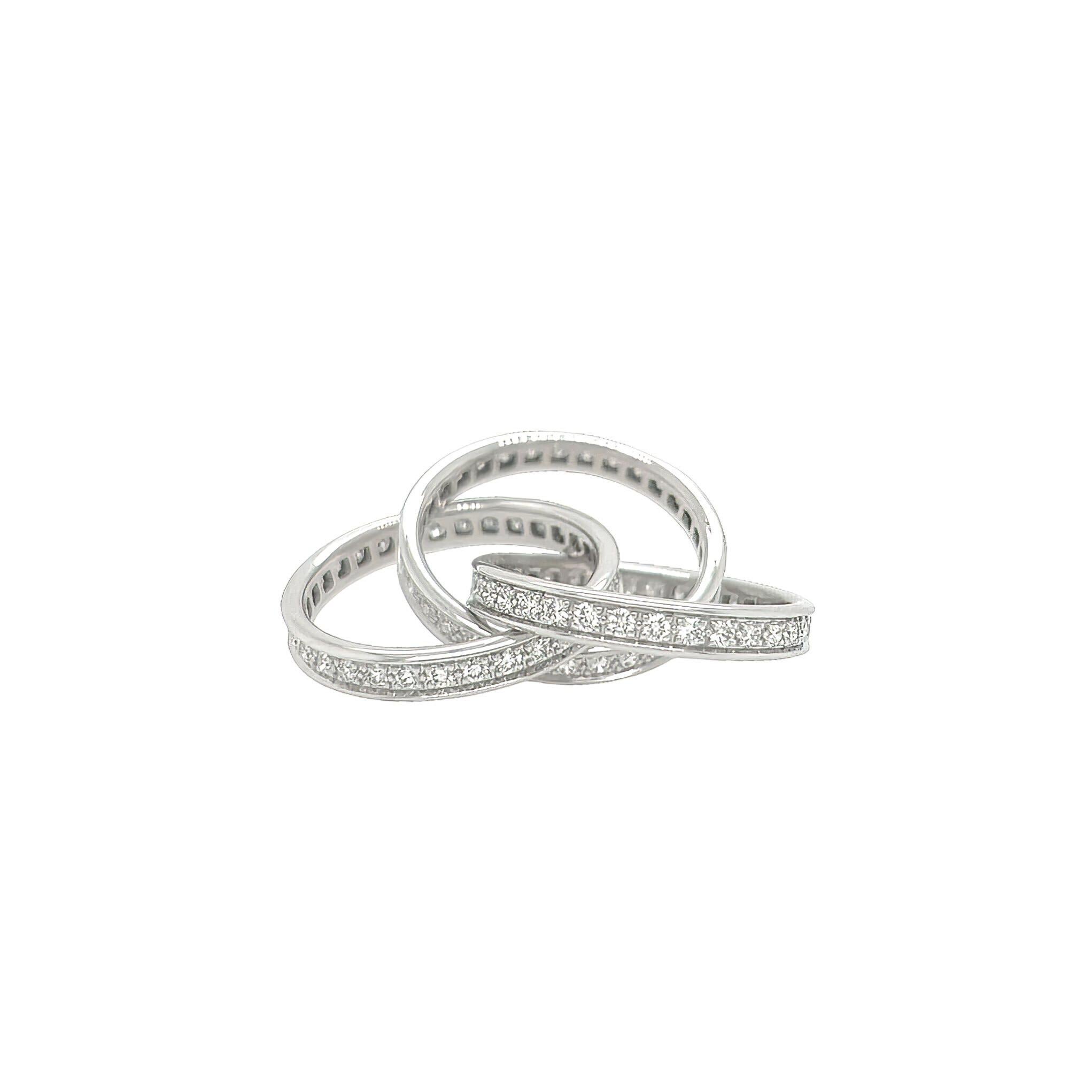 A Cartier 18 karat white gold & diamond ring, Cartier.  The Trinity ring designed as three interlocking bands set all around with a total of approximately 99 round brilliant cut diamonds.  Total diamond weight approximately 2.48 carats.  Size