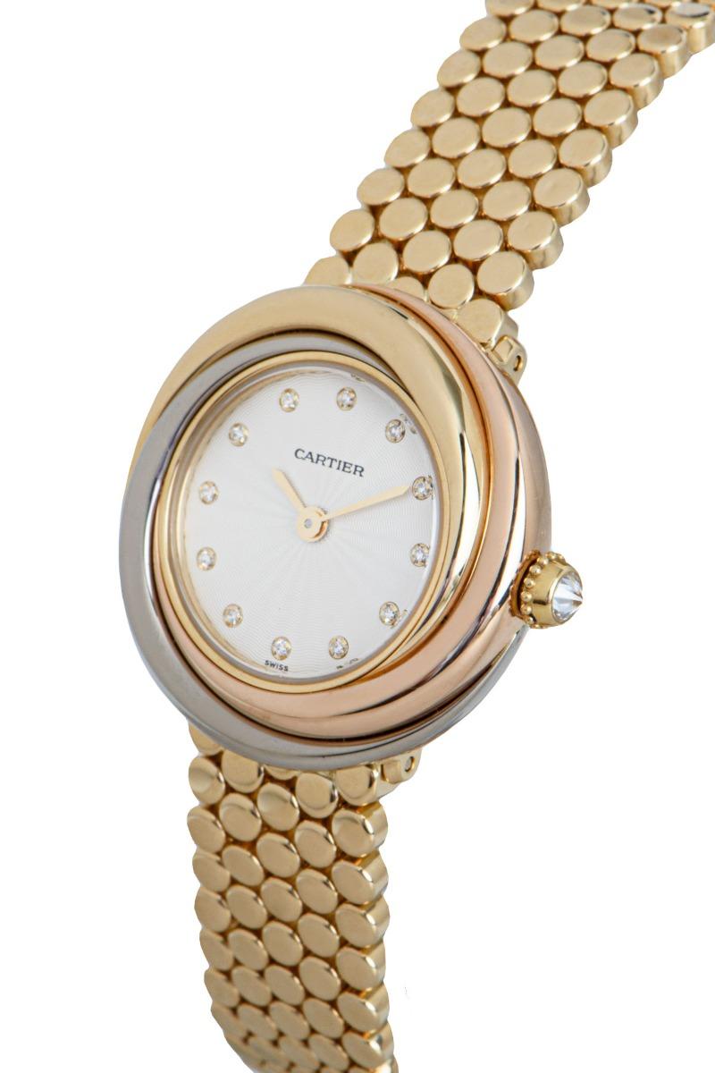 A 27 mm Trinity women's wristwatch, with a diamond set silver dial and a diamond set crown. 

The quartz wristwatch is in excellent condition. It features a fixed 18k tri-gold bezel and case, an 18k yellow gold jewellery style bracelet, a concealed