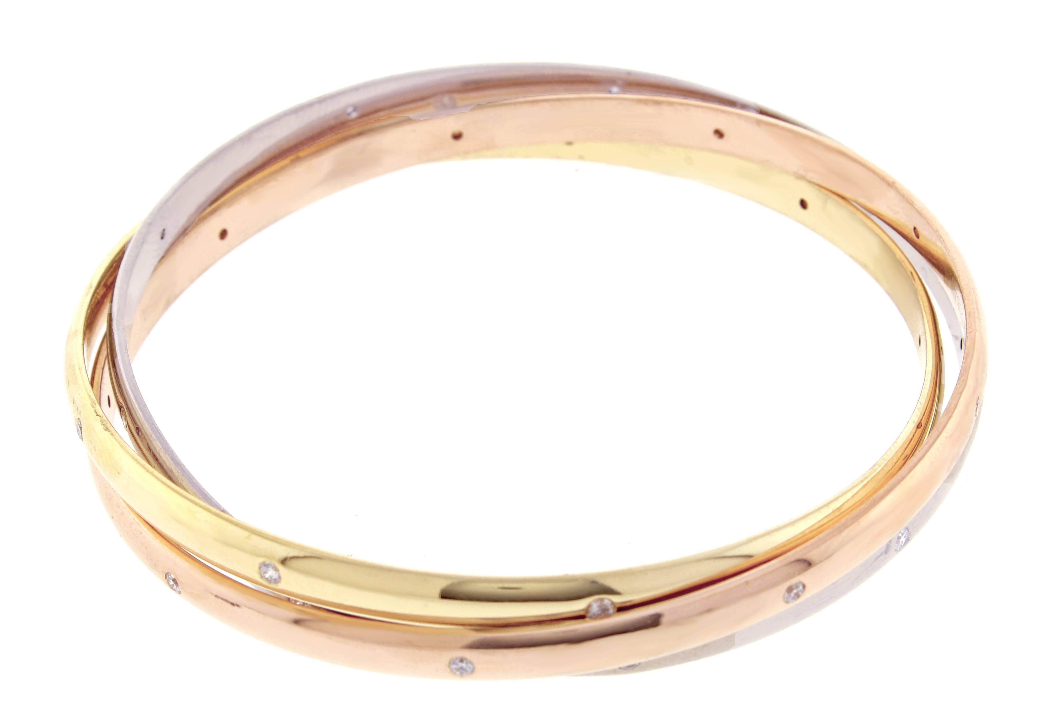 Springing from the imagination of Louis Cartier in 1924, this unique, movable bangle is made of three interlaced bands of yellow gold, white gold, and pink gold. Trinity bracelet, medium model, 18 karat,   27 diamonds weigh approximately .54 carats 