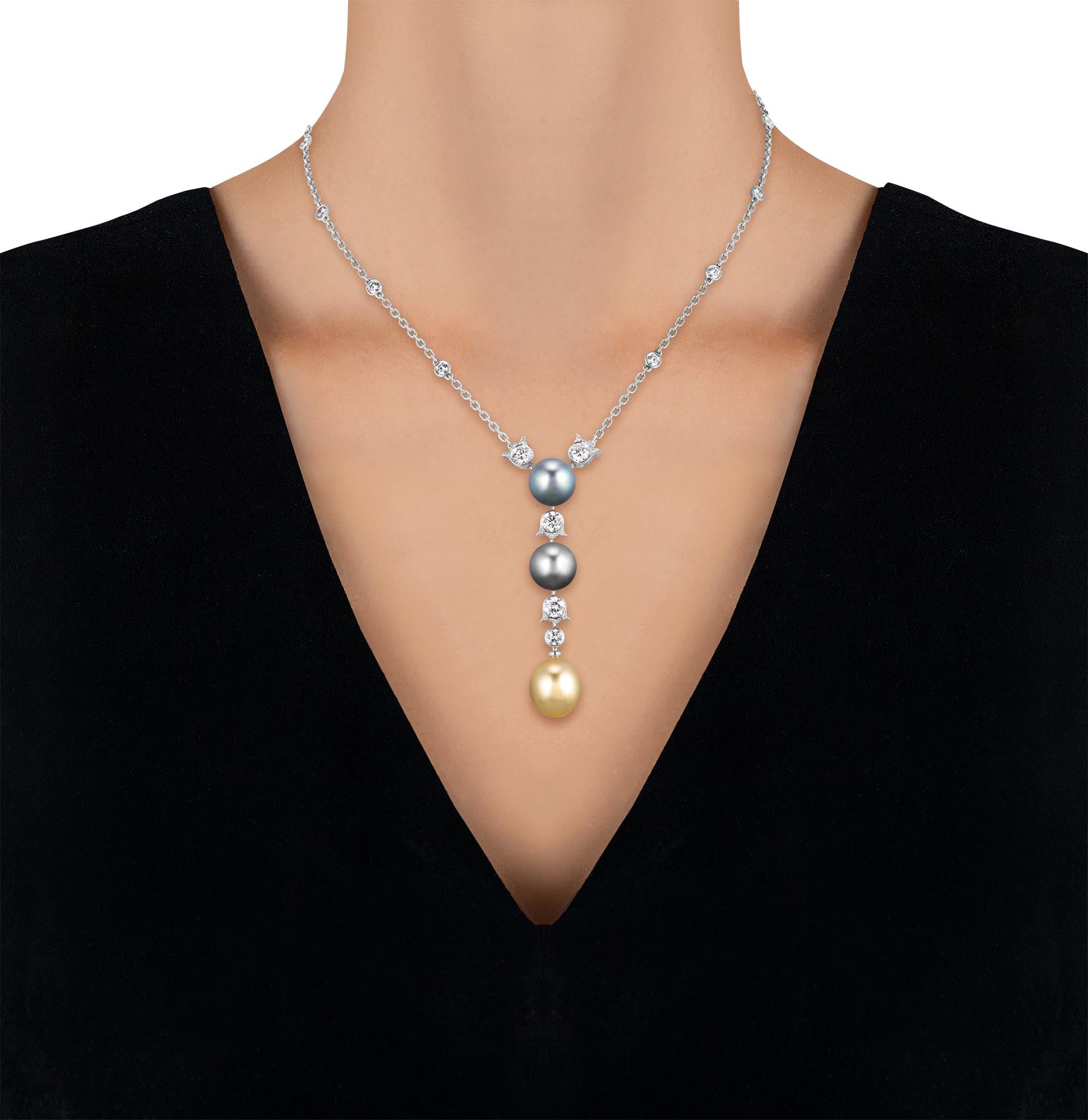 A striking trio of oceanic tones defines this exquisite lavalier by Cartier. Suspended from a white gold chain, the elegant pendant is formed by three lustrous pearls: a rich golden drop pearl and two deep-toned Tahitian round pearls. These natural