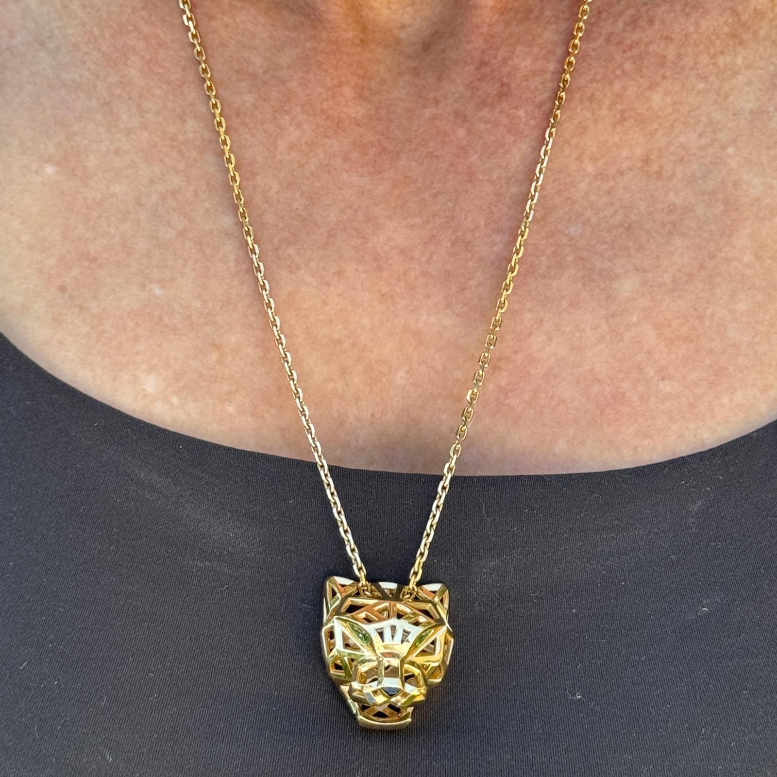 This exceptional Cartier Panthère de Cartier necklace (ref. N7424210) showcases the Maison’s iconic feline motif with unparalleled artistry. Crafted in 18K yellow gold, the pendant features a stylized panther head, distinguished by its green