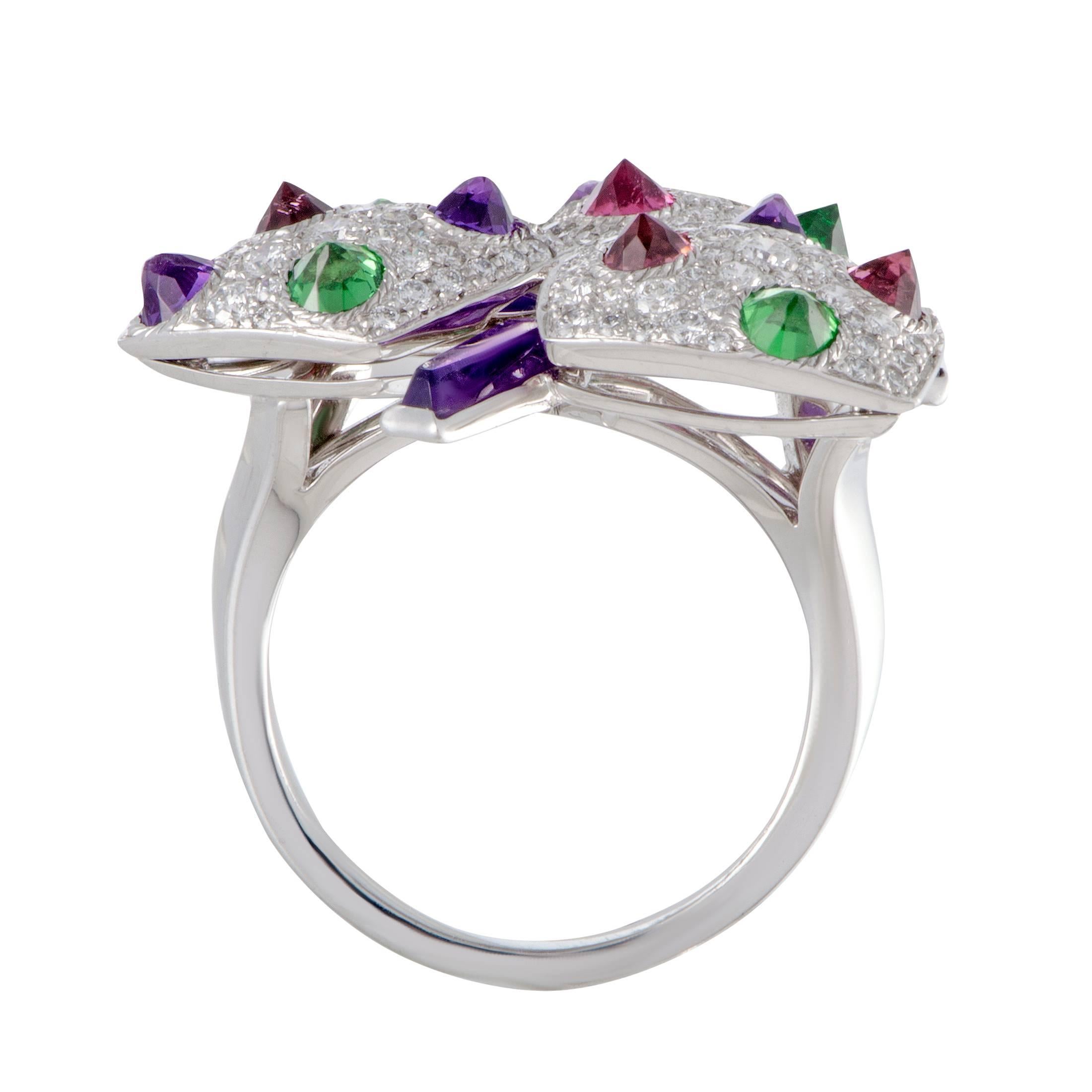 This utterly stunning ring by Cartier is uniquely crafted in the beautiful glisten of 18K white gold. The spectacular design is adorned in gorgeous amethysts, sensational tsavorites, dazzling pink tourmalines and 2.50ct of sparkling diamonds that