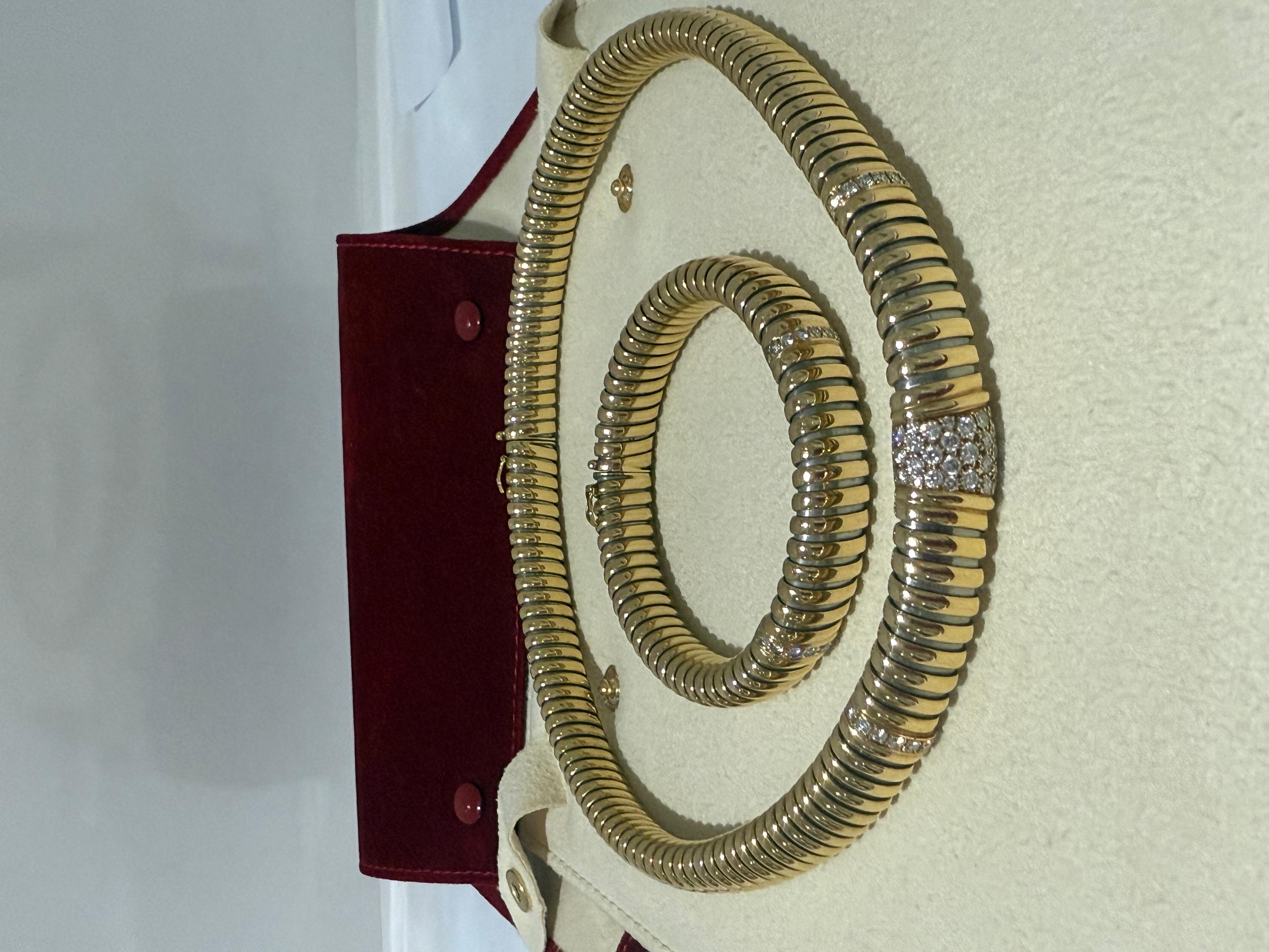 A two-colour diamond Cartier Tubogas collar flex gold and diamond necklace and bracelet set modelled as a 'gas pipe' link collar, with central trapeze shaped panel pavé with round brilliant diamonds and two similarly set spacer bars, to a concealed