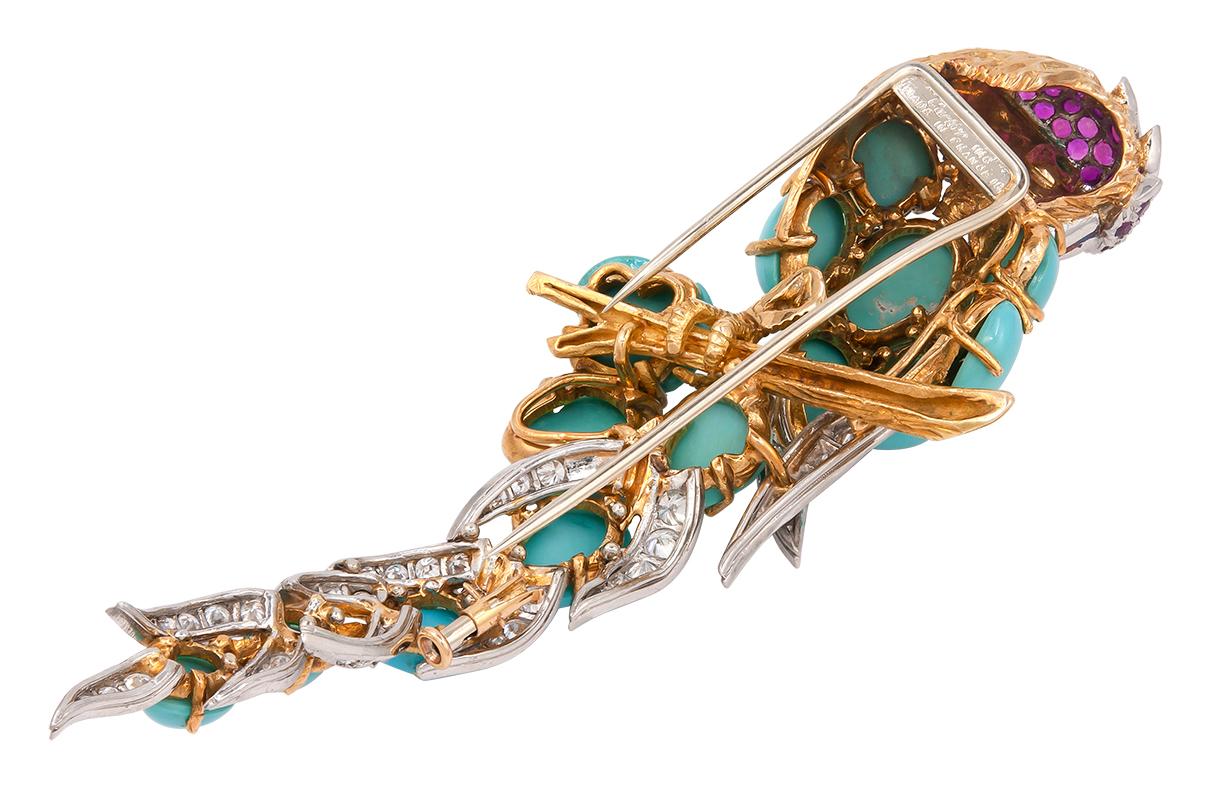 CARTIER Turquoise, Diamond, Emerald Bird Brooch.
An 18k yellow gold and platinum bird brooch, set with cabochon turquoise, emerald and diamonds, Cartier.
measures approx. 4″ in length by 0.75″ in width
Signed “Cartier“, circa 1980s, made in France