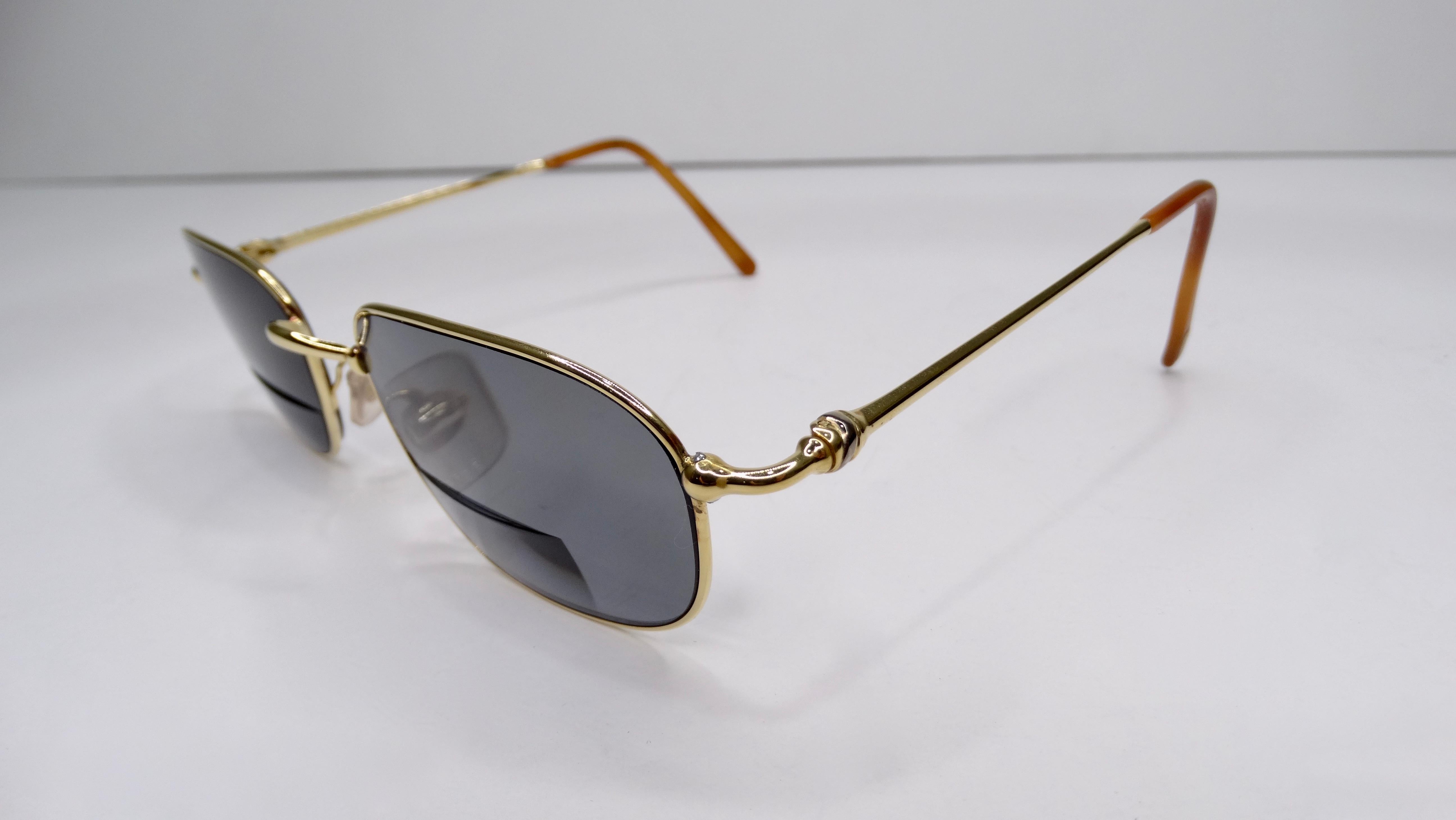 A favorite of both jewelry and fashion lovers, Cartier is always a classic! Circa 1980s, these sunglasses feature a two-tone silver and 18k gold plated frame with a knotted design on the arms. The lenses in these sunglasses are prescription/bifocal