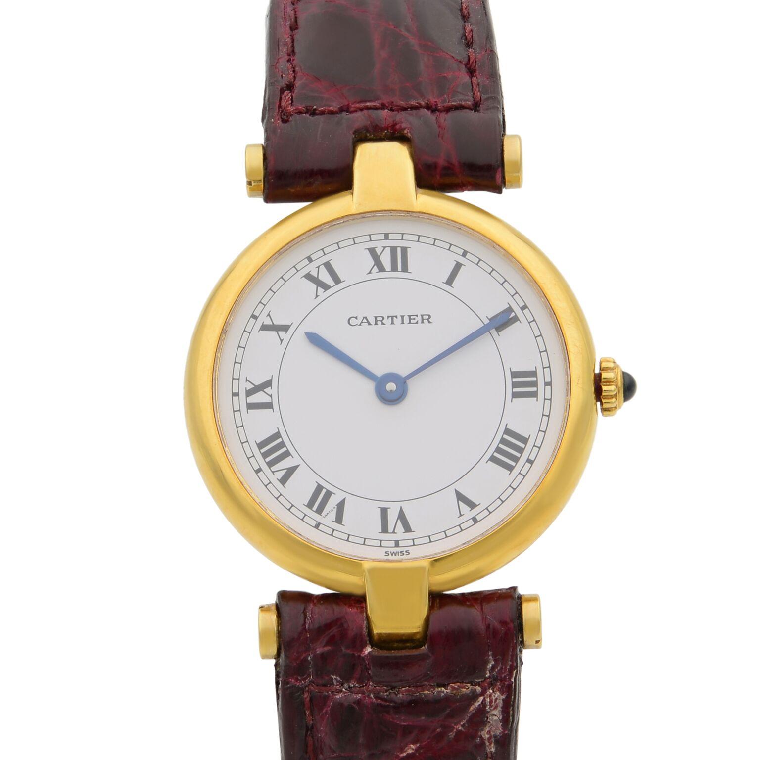 This pre-owned Cartier Vendome 8100 is a beautiful Ladie's timepiece that is powered by quartz (battery) movement which is cased in a yellow gold case. It has a round shape face, no features dial, and has hand roman numerals style markers. It is