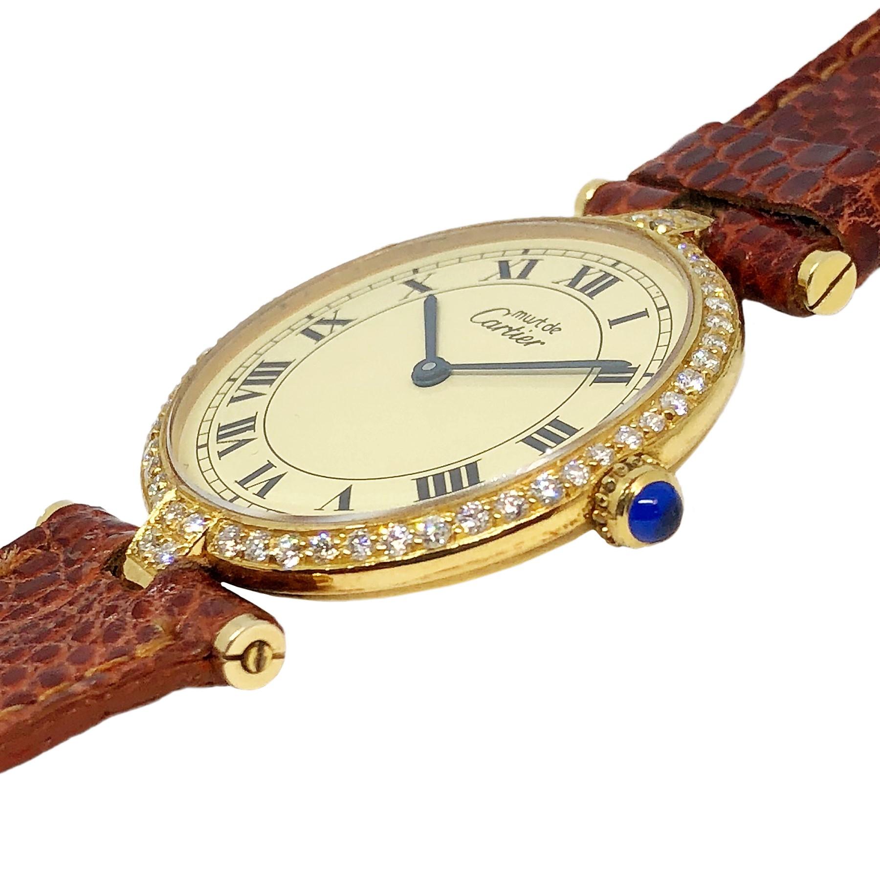 Circa 2005 Cartier Vendome Wrist watch, 30 MM 2 Piece Vermeil ( Gold Plate on .925 Sterling ) case. Quartz Movement, Cream dial with Black Roman numerals. Diamond set bezel of Round Brilliant cuts totaling 1.20 carats. New Brown Lizard strap with