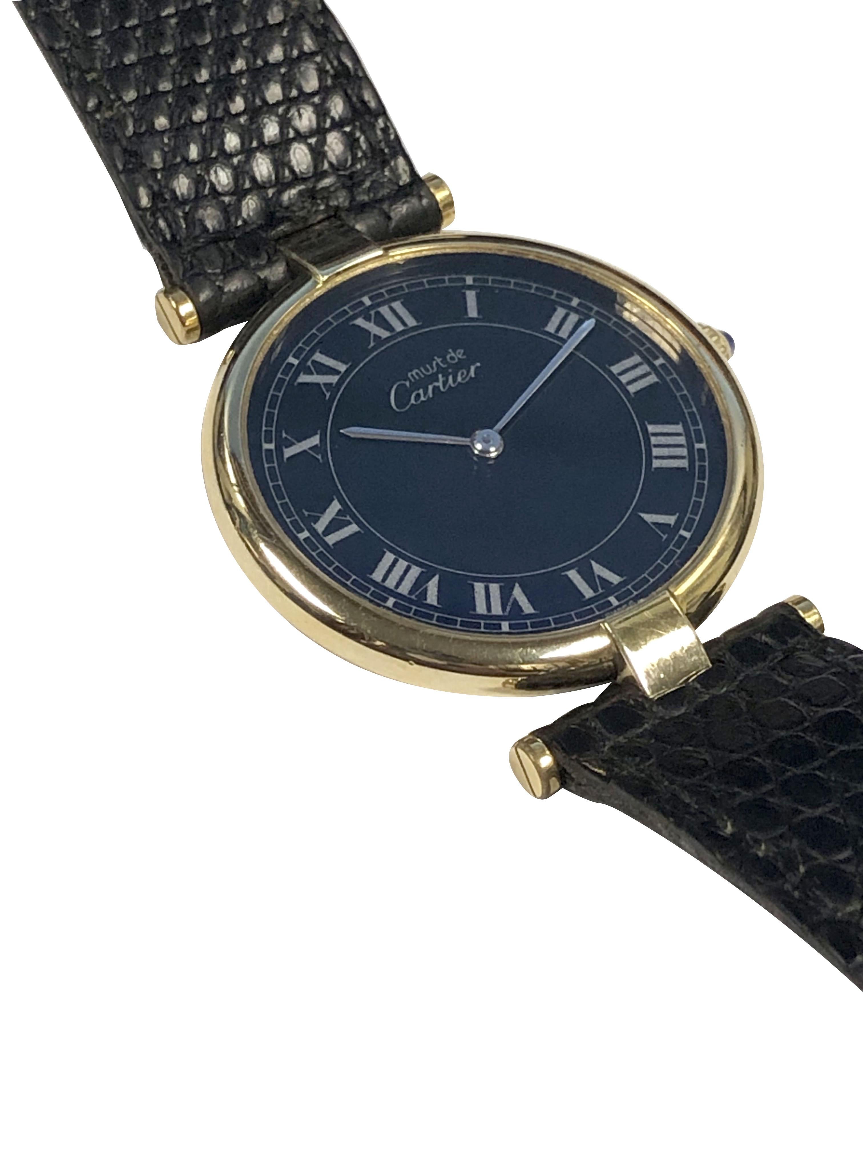 Circa 2000 Cartier, Must De Cartier Vendome collection Wrist Watch, 30 MM Vermeil, ( Gold Plate on Sterling Silver ) 2 piece case. Quartz Movement, Sapphire Crown, Black dial with Silver Roman numerals. Original Cartier Black Lizard strap with