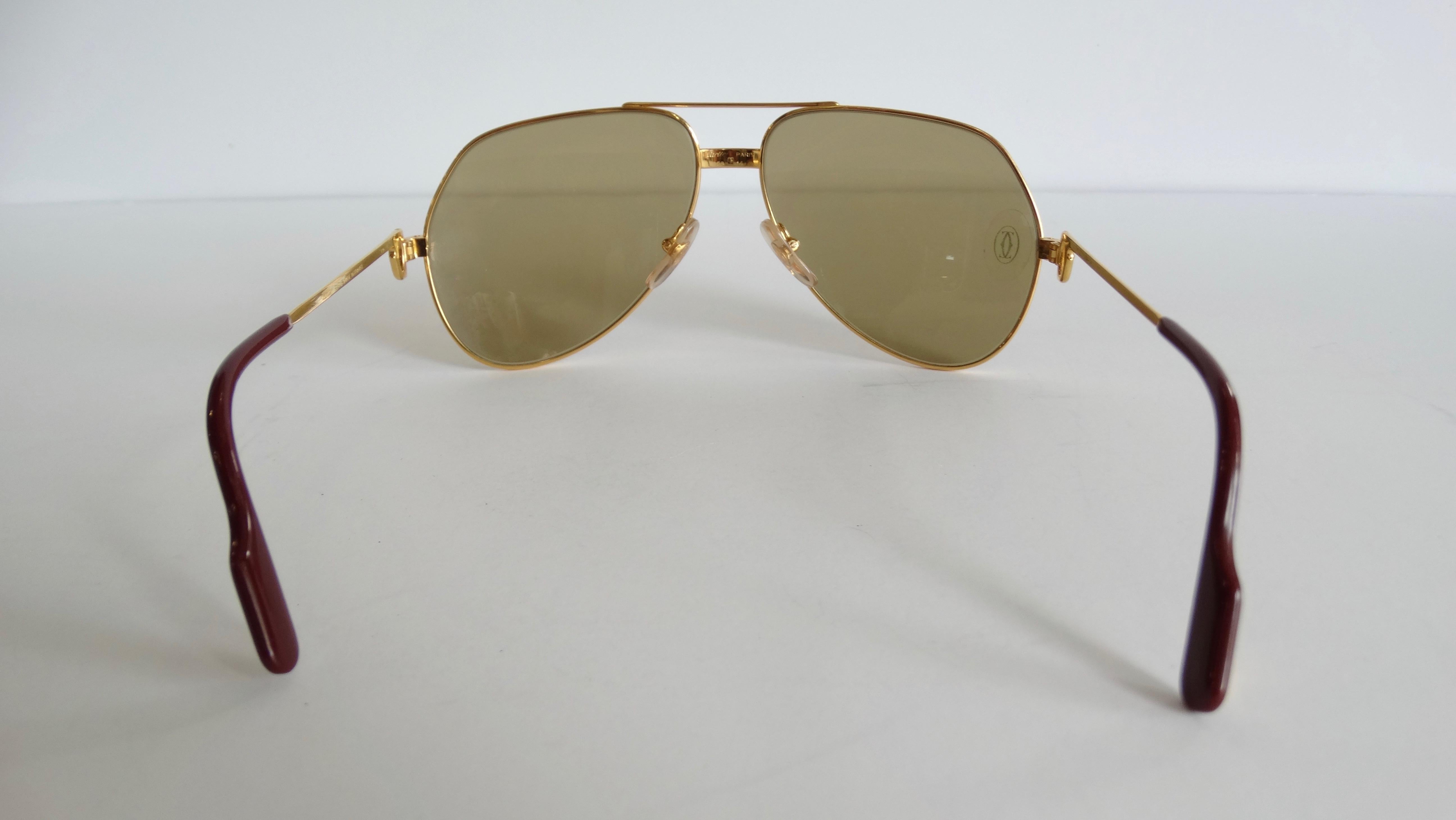 Snag yourself the ultimate pair of vintage sunnies! Circa 1983-1997, these Cartier aviator sunglasses are famously known as the Vendome Louis, are mixed silver/gold plated and feature brown tinted lenses with the Cartier logo engraved. Arms include