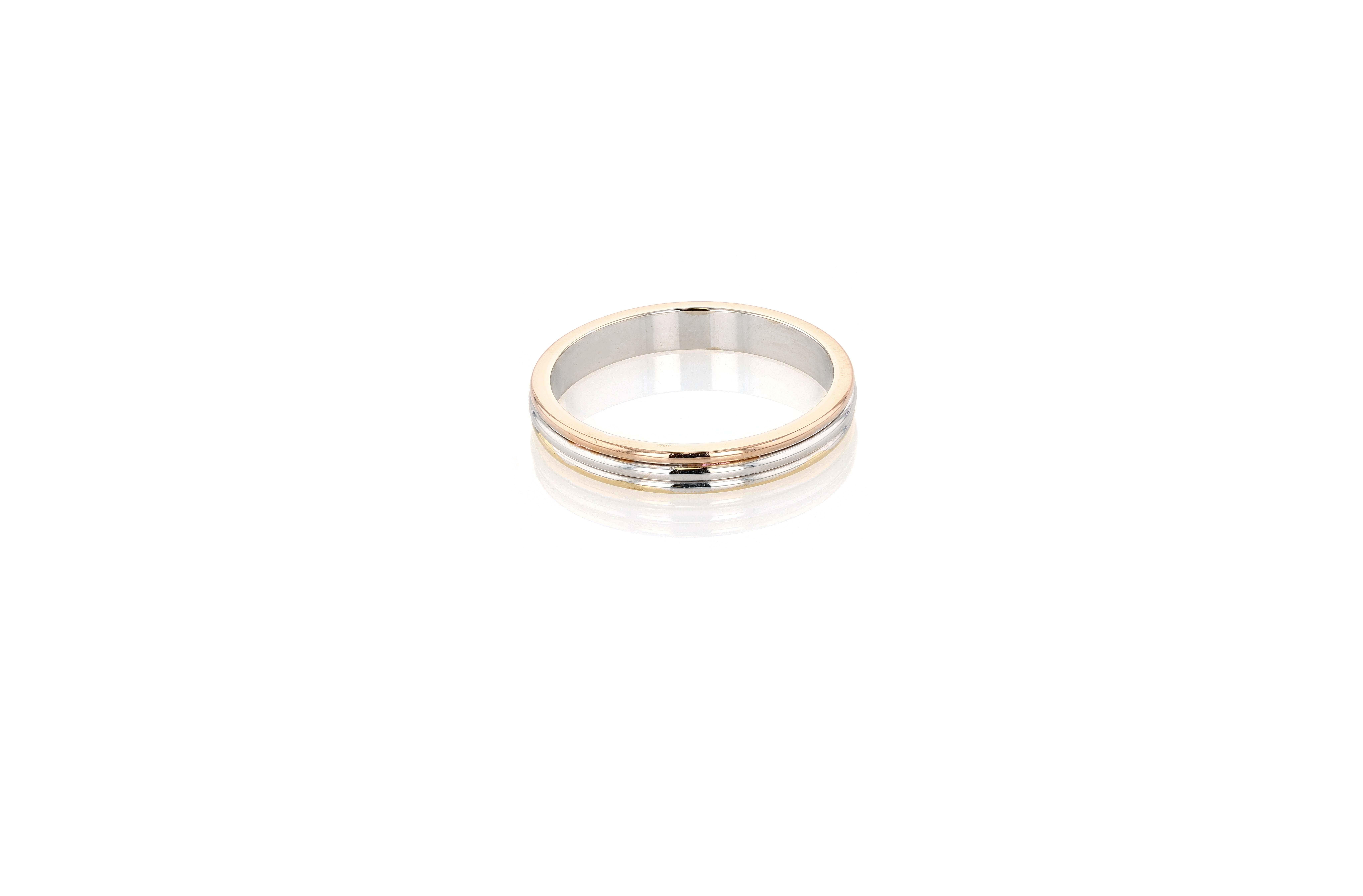 A Cartier Yellow Gold, Rose Gold, and White Gold band ring from the Vendome collection, a pared down expression of the original Trinity de Cartier. Cartier Trinity was created in 1924, allegedly at the behest of Jean Cocteau who was obsessed with