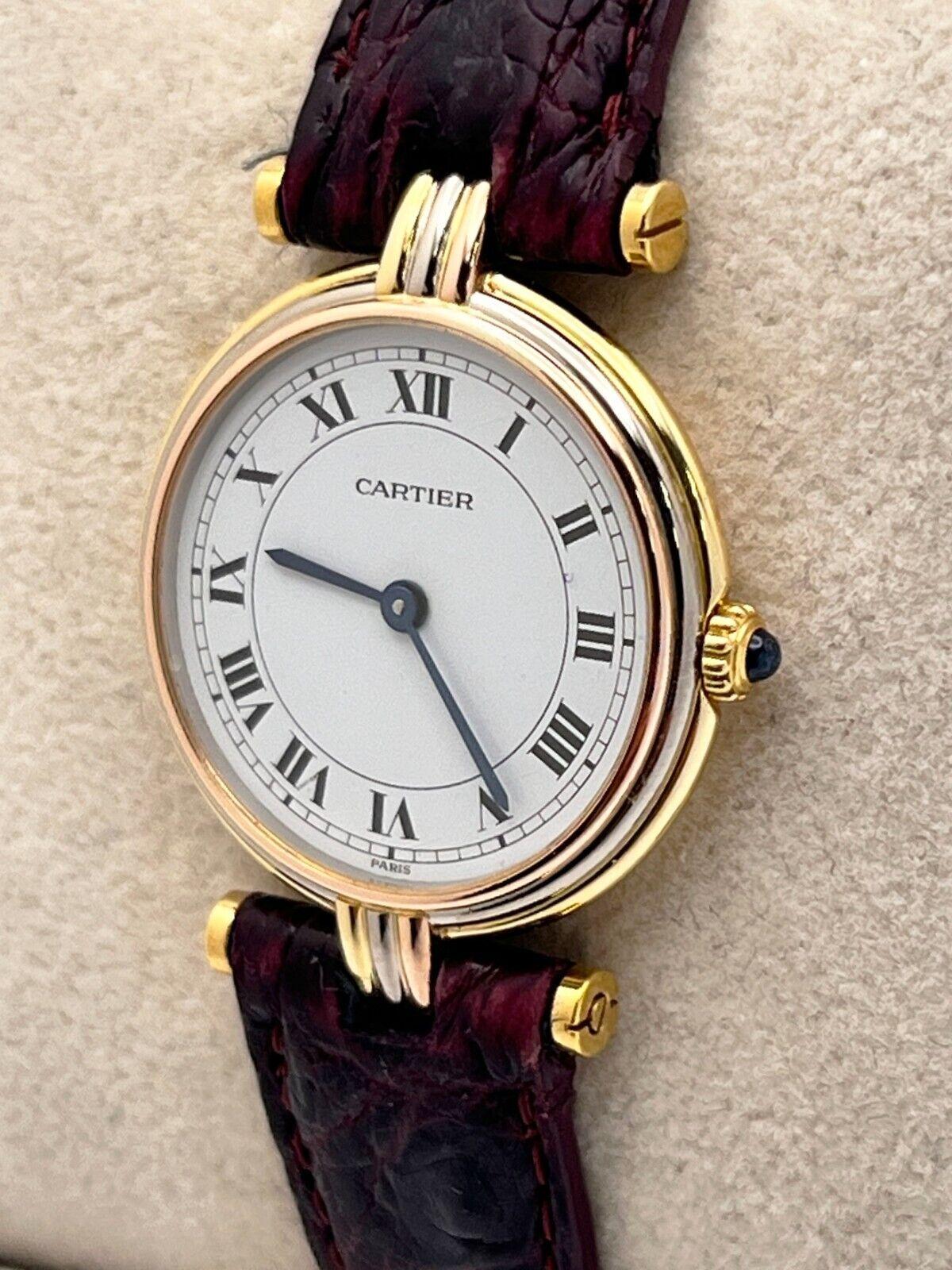 Style Number: 8100
Year: Estimated 1990's
Model: Cartier Vendome Trinity 
Case Material: 18K Yellow Gold
Band: Leather Brown
Dial: White
Face: Sapphire Crystal 
Case Size: 24 mm 
Includes: 
-Elegant Watch Box
-Certified Appraisal 
-1 Year Warranty


